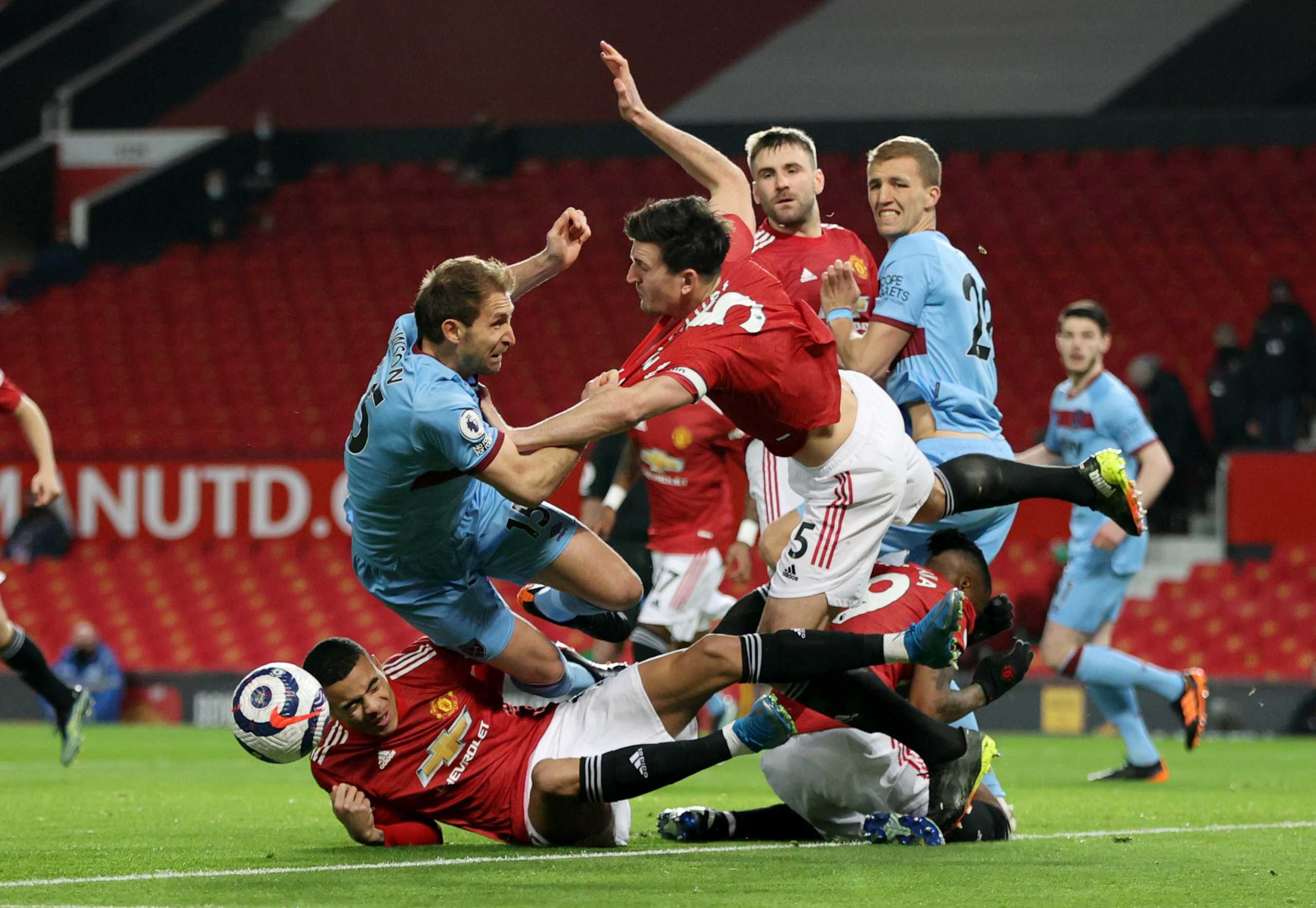 Soccer Football - Premier League - Manchester United v West Ham United - Old Trafford, Manchester, Britain - March 14, 2021 Manchester United's Harry Maguire in action with West Ham United's Craig Dawson Pool via REUTERS