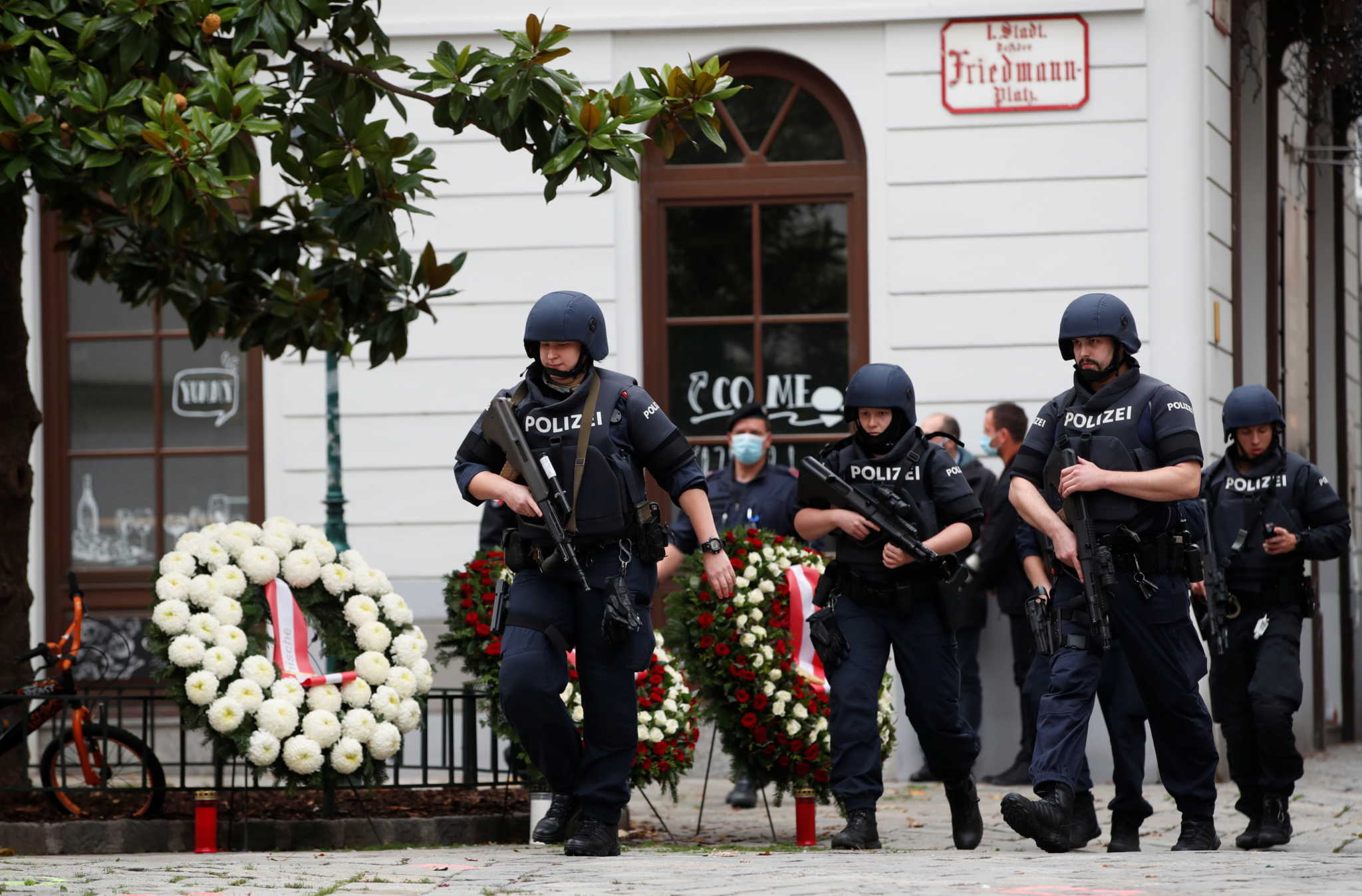 Police officers walk at the site of wreath laying ceremony after exchanges of gunfire in Vienna, Austria November 3, 2020. REUTERS