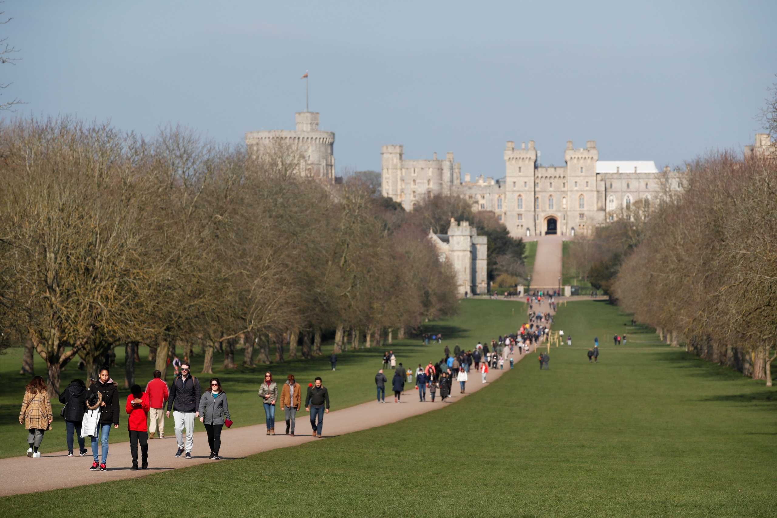 Windsor castle is seen as people walk on the Long Walk, amid the outbreak of the coronavirus disease (COVID-19), in Windsor, Britain, March 7, 2021. REUTERS