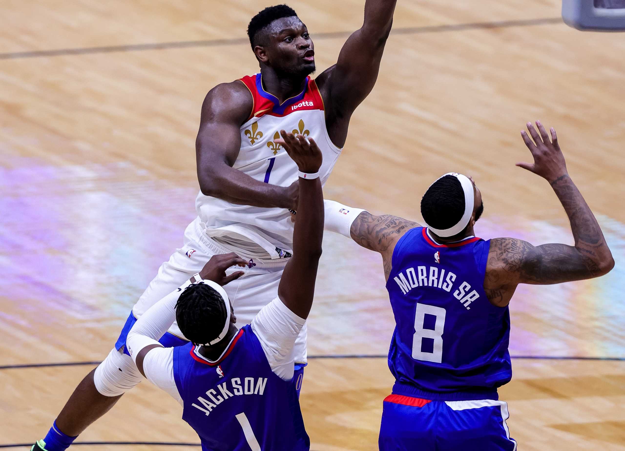 Mar 14, 2021; New Orleans, Louisiana, USA;  New Orleans Pelicans forward Zion Williamson (1) shoots a lay up against LA Clippers guard Reggie Jackson (1) and forward Marcus Morris Sr. (8) during the second half at the Smoothie King Center. Mandatory Credit: Stephen Lew-USA TODAY Sports
