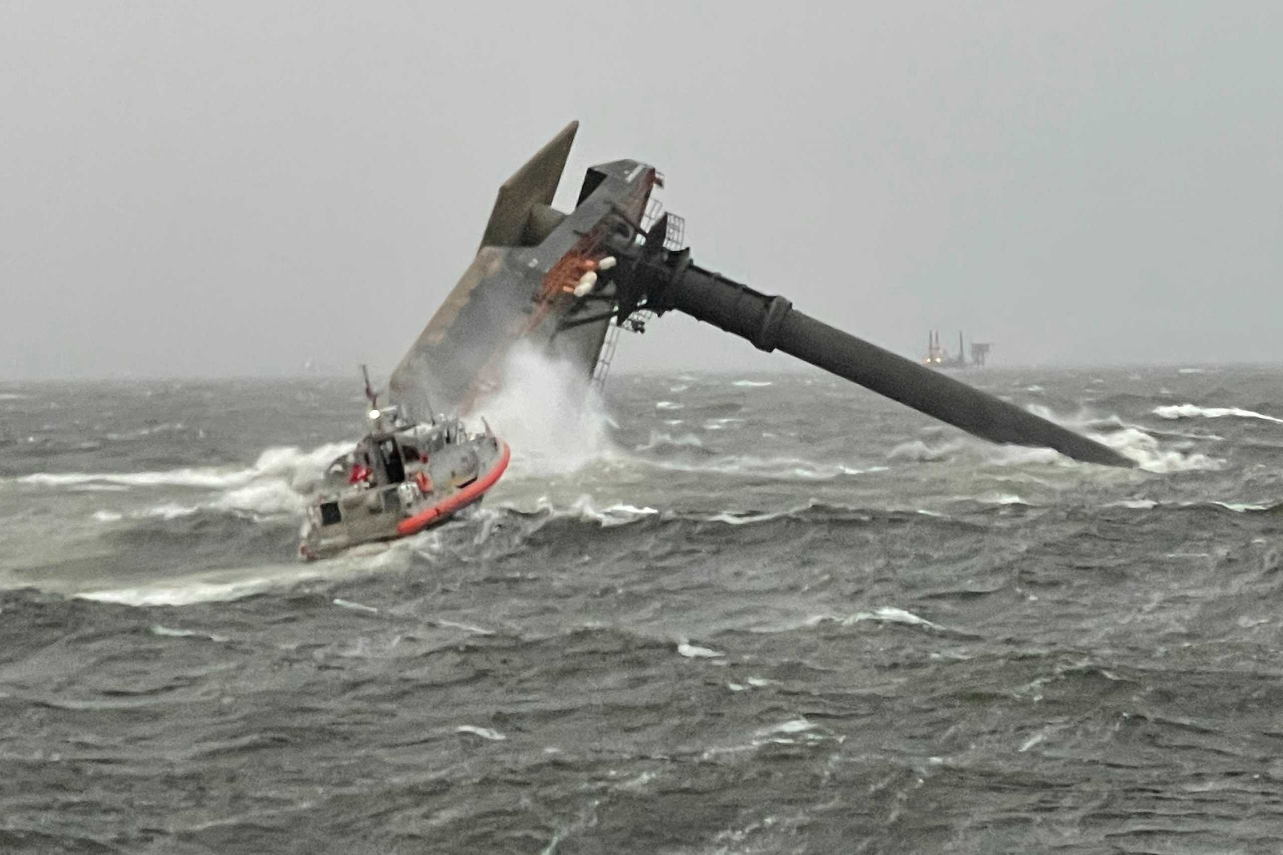 A Coast Guard Station Grand Isle boatcrew heads toward a capsized 175-foot commerical lift boat while searching for people in the water 8 miles (about 13 km) south of Grand Isle, Louisiana, U.S. April 13, 2021. Picture taken April 13, 2021.  U.S. Coast Guard