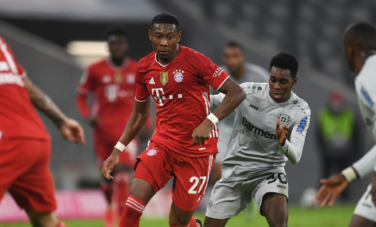 Soccer Football - Bundesliga - Bayern Munich v Bayer Leverkusen - Allianz Arena, Munich, Germany - April 20, 2021 Bayern Munich's David Alaba in action with Bayer Leverkusen's Jeremie Frimpong Pool via REUTERS