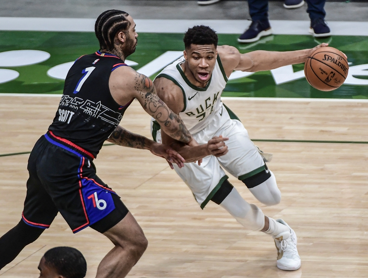 Apr 22, 2021; Milwaukee, Wisconsin, USA; Milwaukee Bucks forward Giannis Antetokounmpo (34) drives to the basket against Philadelphia 76ers forward Mike Scott (1) in the first quarter at Fiserv Forum. Mandatory Credit: Benny Sieu-USA TODAY Sports