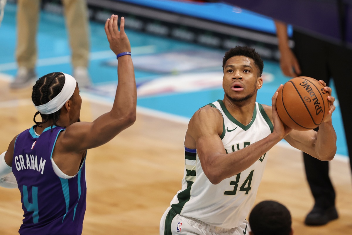 Apr 27, 2021; Charlotte, North Carolina, USA; Milwaukee Bucks forward Giannis Antetokounmpo (34) looks to shoot against Charlotte Hornets guard Devonte' Graham (4) during the third quarter at Spectrum Center. Mandatory Credit: Nell Redmond-USA TODAY Sports