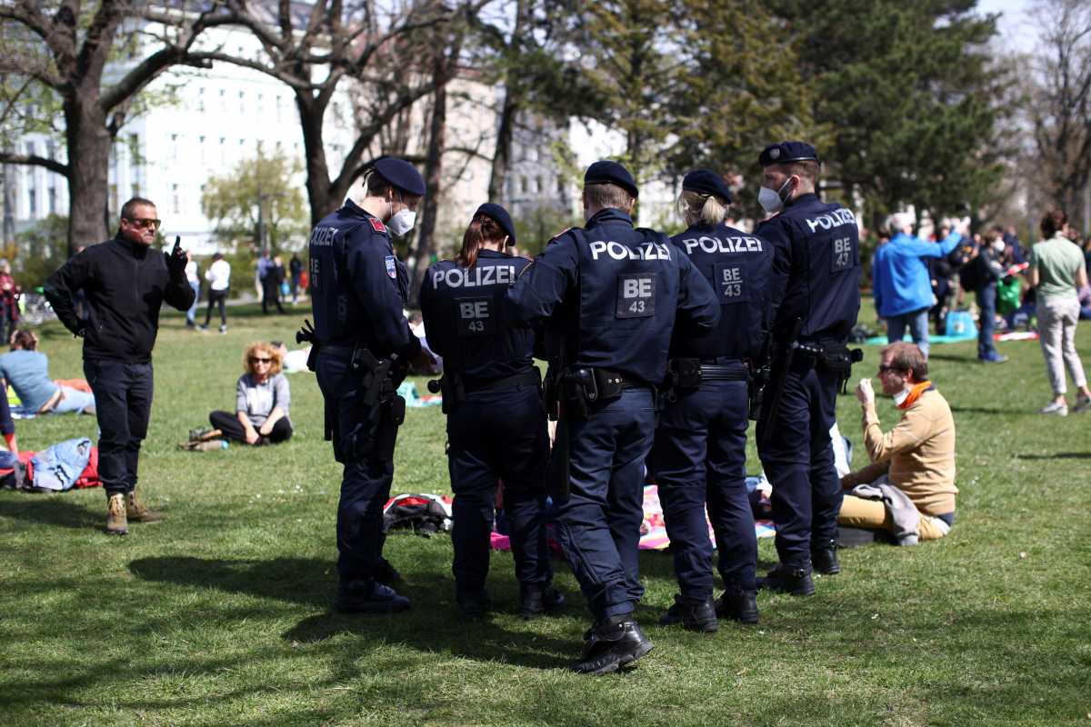 Police officers control individuals as demonstrators gather to protest against the coronavirus disease (COVID-19) measures in Vienna, Austria, April 10, 2021. REUTERS