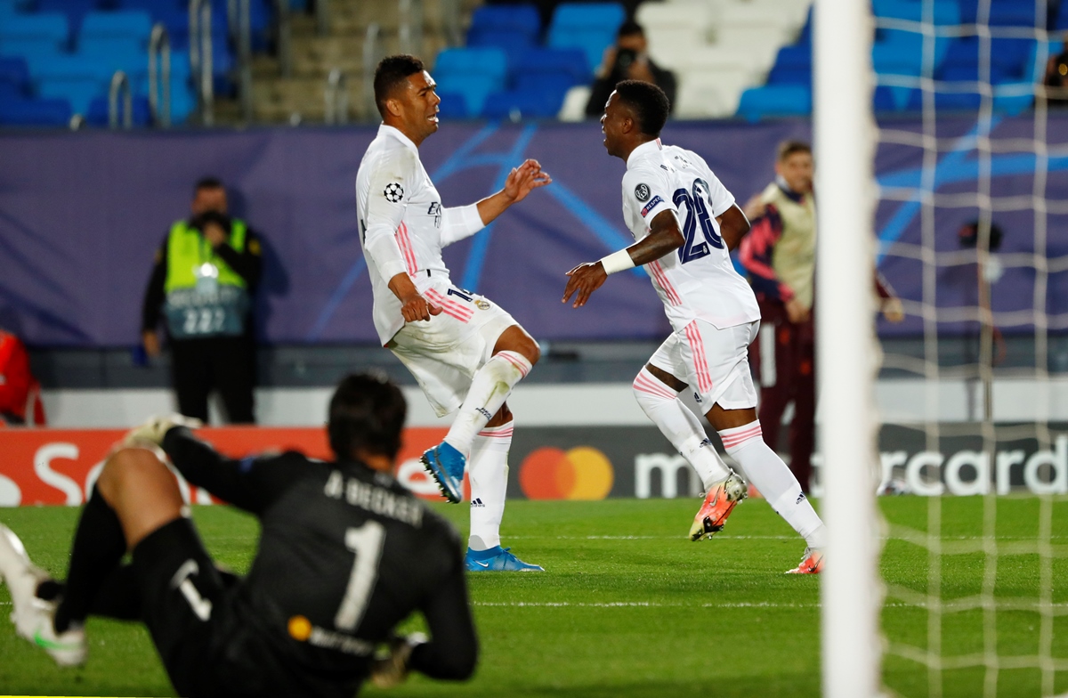 Soccer Football - Champions League - Quarter Final - First Leg - Real Madrid v Liverpool - Estadio Alfredo Di Stefano, Madrid, Spain - April 6, 2021 Real Madrid's Vinicius Junior celebrates scoring their third goal with teammates REUTERS