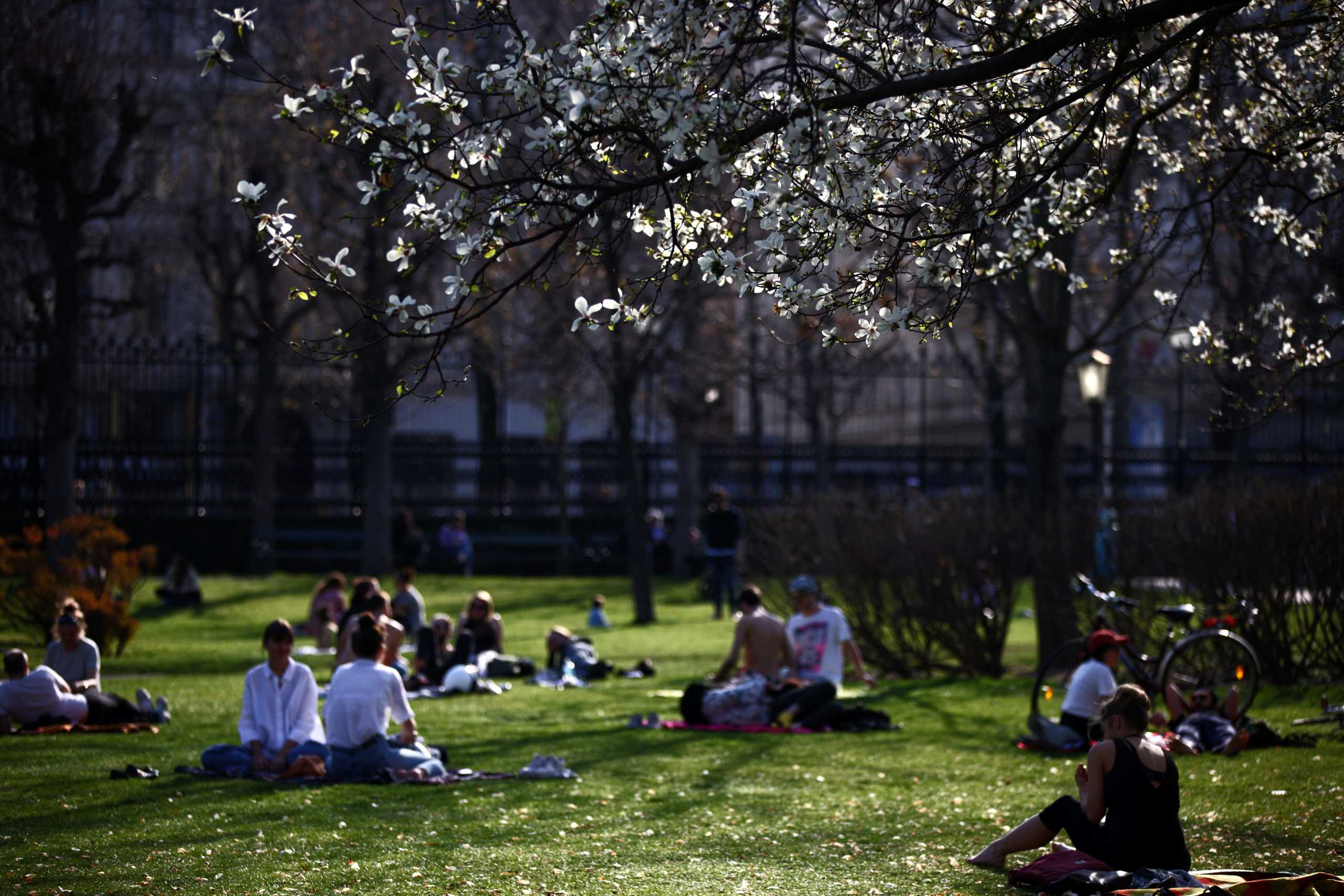 People enjoy the sun on a warm spring day at Burggarten park amid the coronavirus disease (COVID-19) outbreak in Vienna, Austria, April 1, 2021. REUTERS