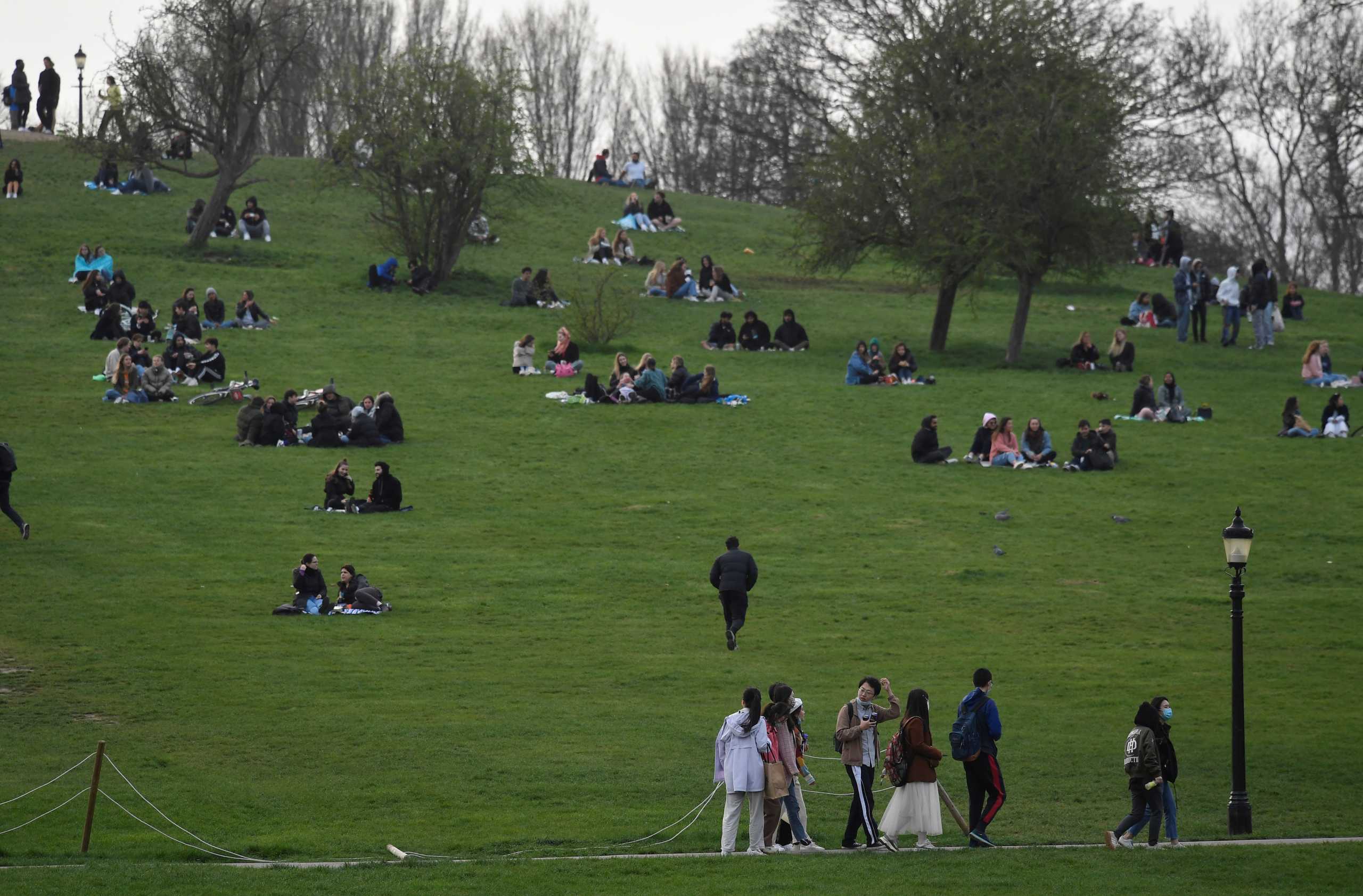 People socialise in Primrose Hill park as lockdown restrictions are eased in England, amid the spread of the coronavirus disease (COVID-19), in London, Britain, April 1, 2021. REUTERS