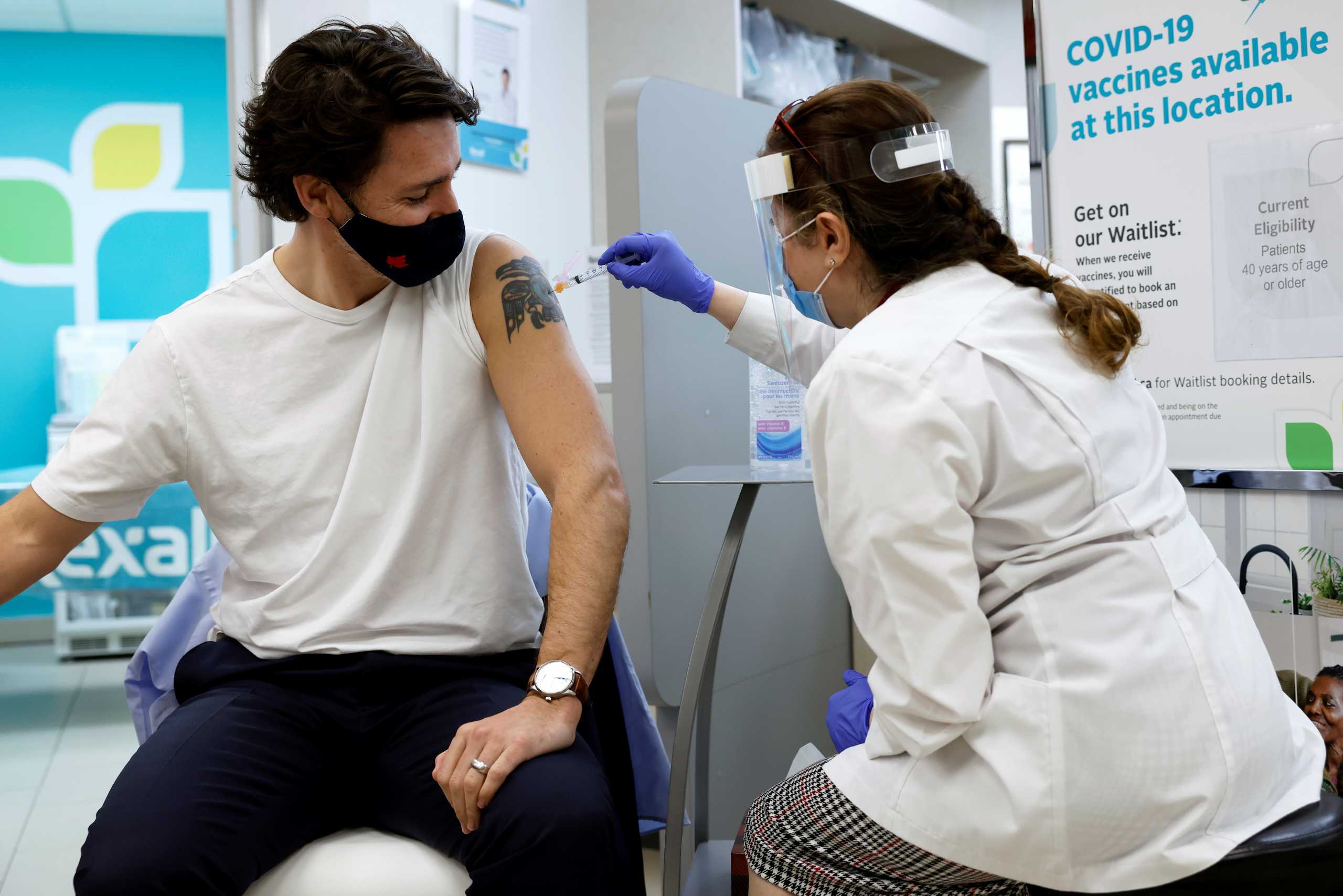 Canada's Prime Minister Justin Trudeau is inoculated with AstraZeneca's vaccine against coronavirus disease (COVID-19) at a pharmacy in Ottawa, Ontario, Canada April 23, 2021.   REUTERS