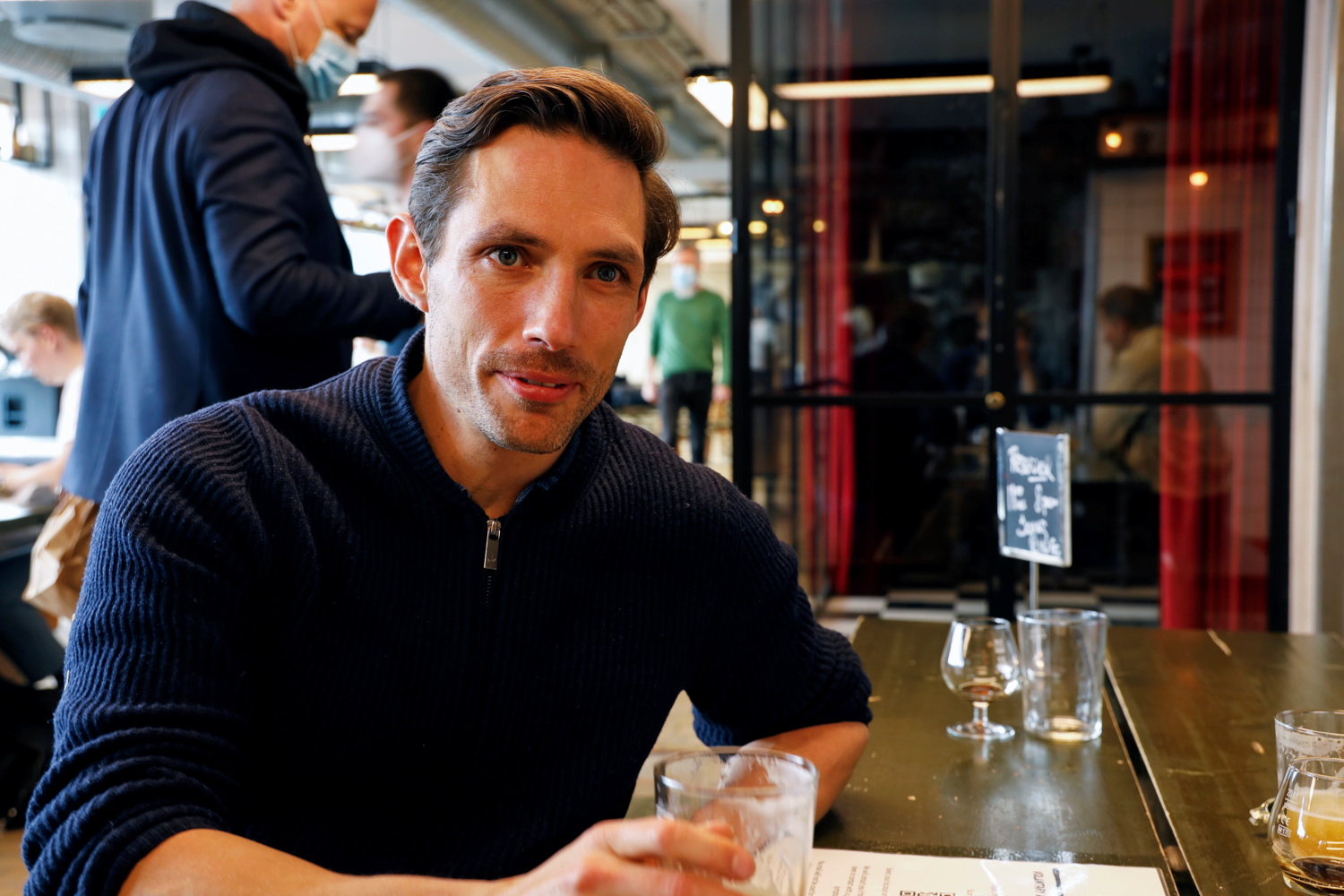 Jonas Nilsen, CEO of the private medical company Practio, enjoys a beer at a bar where his company performs coronavirus disease (COVID-19) antigen tests, in central Copenhagen, Denmark, April 23, 2021. Picture taken on April 23, 2021. REUTERS
