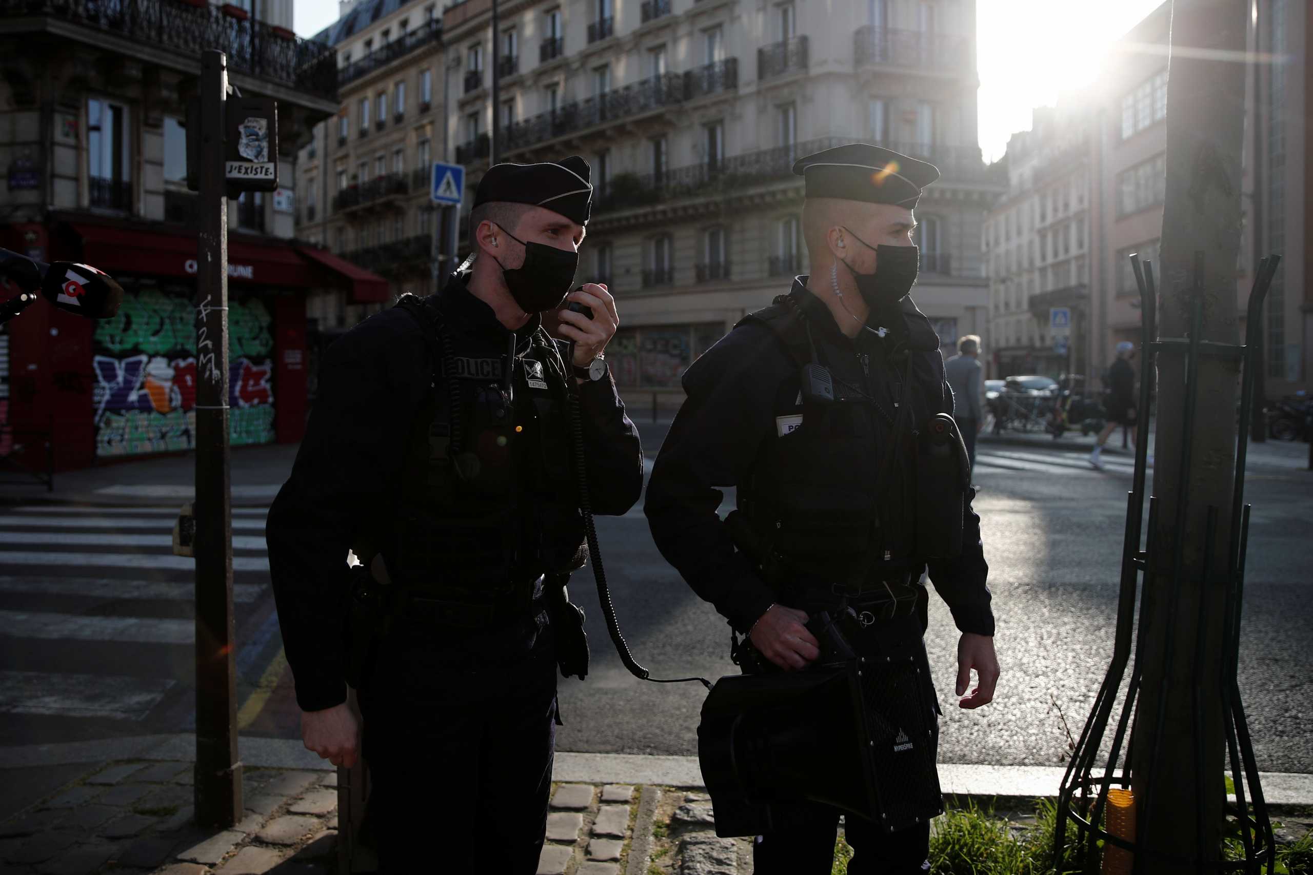 Police officers check people enjoying a sunny spring day along the banks of the canal Saint-Martin to enforce lockdown regulations, amid the coronavirus disease (COVID-19) outbreak, in Paris, France, April 4, 2021. REUTERS