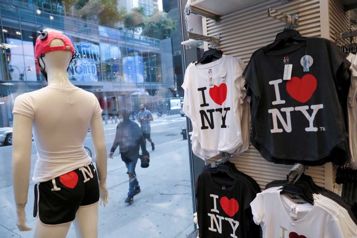 FILE PHOTO: People walk by a store selling tourist souvenirs in the Times Square Area of Manhattan, New York City, U.S., September 26, 2020. REUTERS