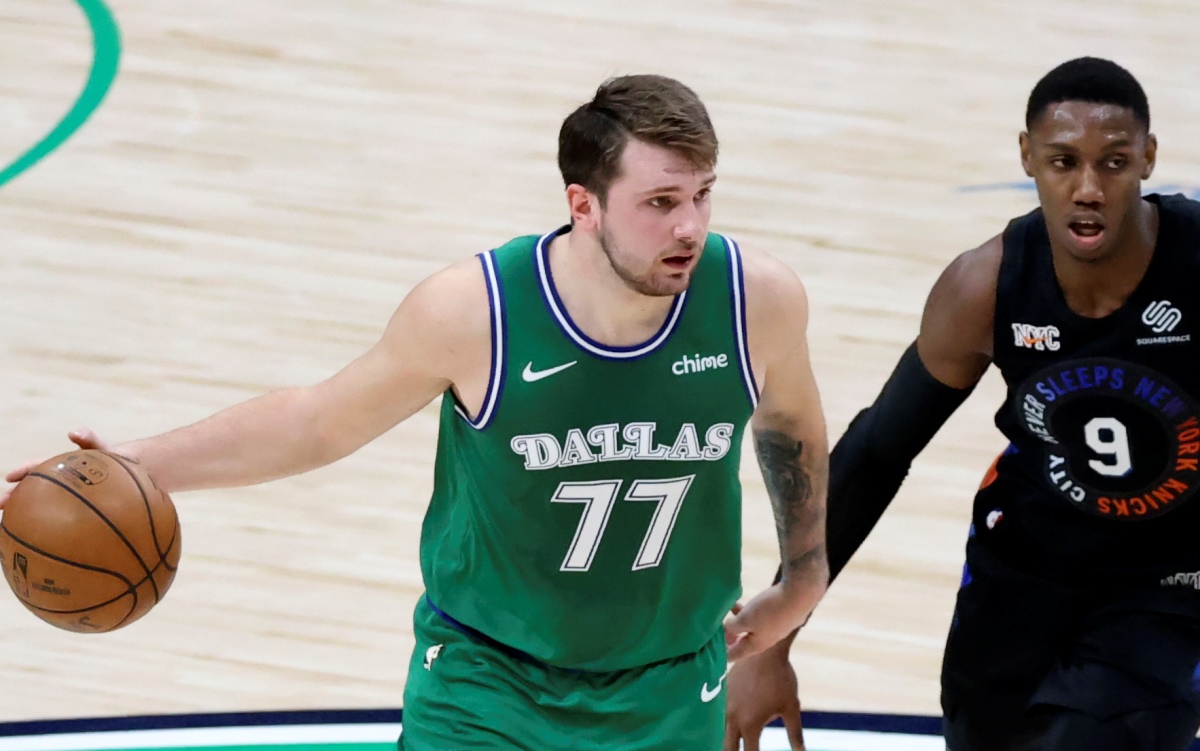 Apr 16, 2021; Dallas, Texas, USA;  Dallas Mavericks guard Luka Doncic (77) dribbles past New York Knicks guard RJ Barrett (9) during the second quarter at American Airlines Center. Mandatory Credit: Kevin Jairaj-USA TODAY Sports