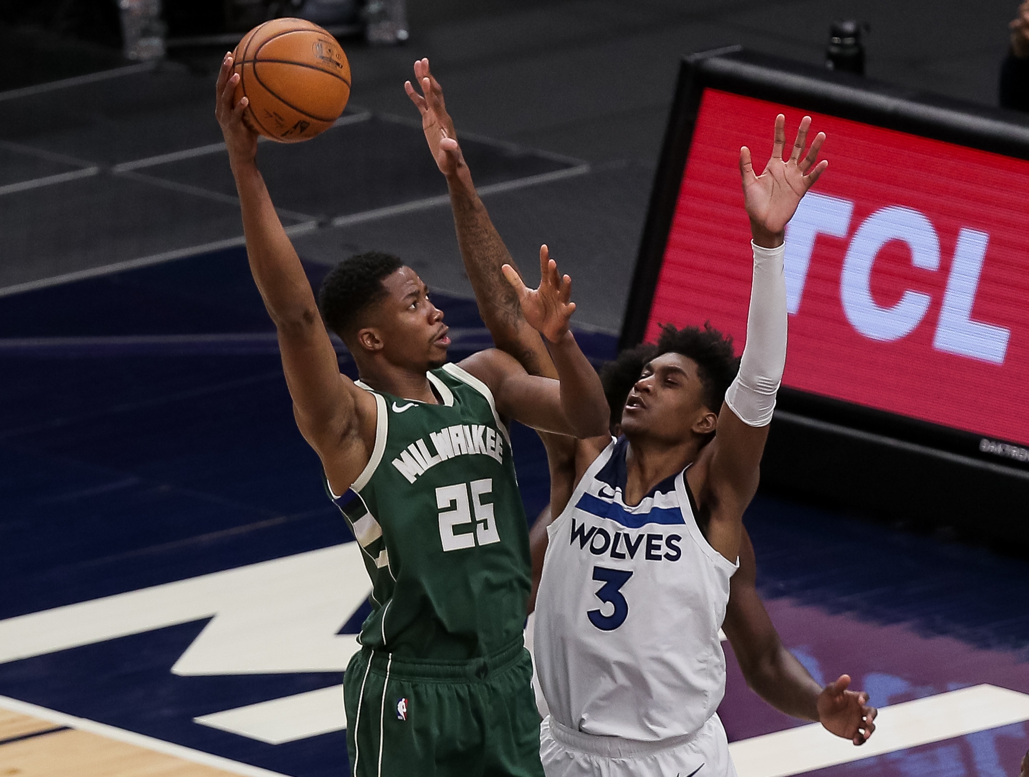 Apr 14, 2021; Minneapolis, Minnesota, USA; Milwaukee Bucks forward Mamadi Diakite (25) shoots against Minnesota Timberwolves forward Jaden McDaniels (3) in the fourth quarter at Target Center. Mandatory Credit: Brad Rempel-USA TODAY Sports