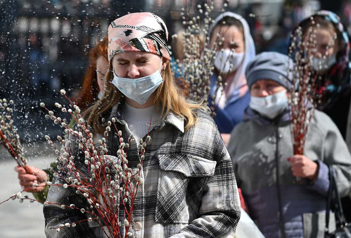 Believers wearing protective masks are sprayed with holy water during a service, which marks the Orthodox feast of Palm Sunday, amid the coronavirus disease (COVID-19) outbreak in Rostov-on-Don, Russia April 25, 2021. REUTERS