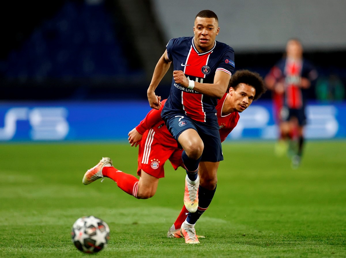Soccer Football - Champions League - Quarter Final Second Leg - Paris St Germain v Bayern Munich - Parc des Princes, Paris, France - April 13, 2021 Paris St Germain's Kylian Mbappe in action with Bayern Munich's Leroy Sane REUTERS