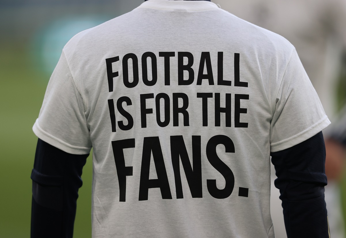 Soccer Football - Premier League - Leeds United v Liverpool - Elland Road, Leeds, Britain - April 19, 2021 A Leeds United player during the warm up before the match wearing UEFA Champions League T- Shirts with the message saying Football is for the Fans Pool via REUTERS