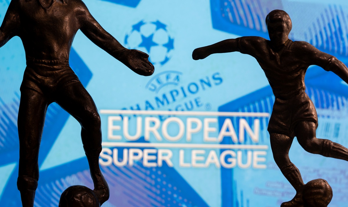 Metal figures of football players are seen in front of the words "European Super League" and the UEFA Champions League logo in this illustration taken April 20, 2021. REUTERS
