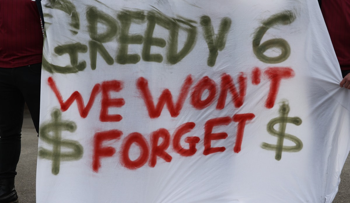 Soccer Football - Premier League - Aston Villa v Manchester City - Villa Park, Birmingham, Britain - April 21, 2021 Aston Villa fans with a banner in protest against the European Super League outside the stadium before the match REUTERS
