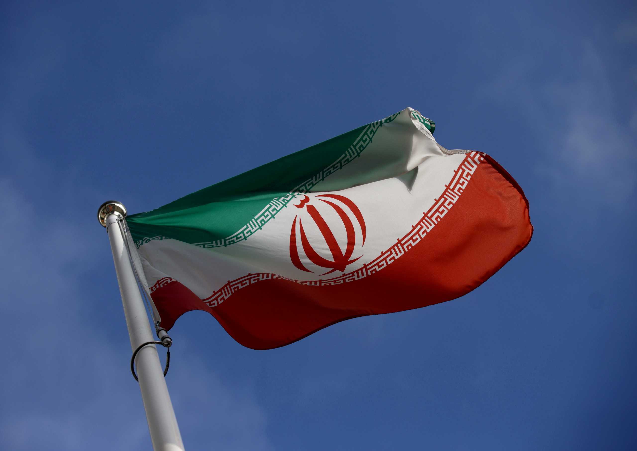 FILE PHOTO: The Iranian flag waves in front of the International Atomic Energy Agency (IAEA) headquarters, before the beginning of a board of governors meeting, in Vienna, Austria, March 1, 2021. REUTERS