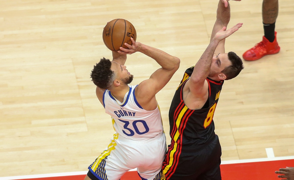 Apr 4, 2021; Atlanta, Georgia, USA; Golden State Warriors guard Stephen Curry (30) shoots past Atlanta Hawks forward Danilo Gallinari (8) in the first quarter at State Farm Arena. Mandatory Credit: Brett Davis-USA TODAY Sports