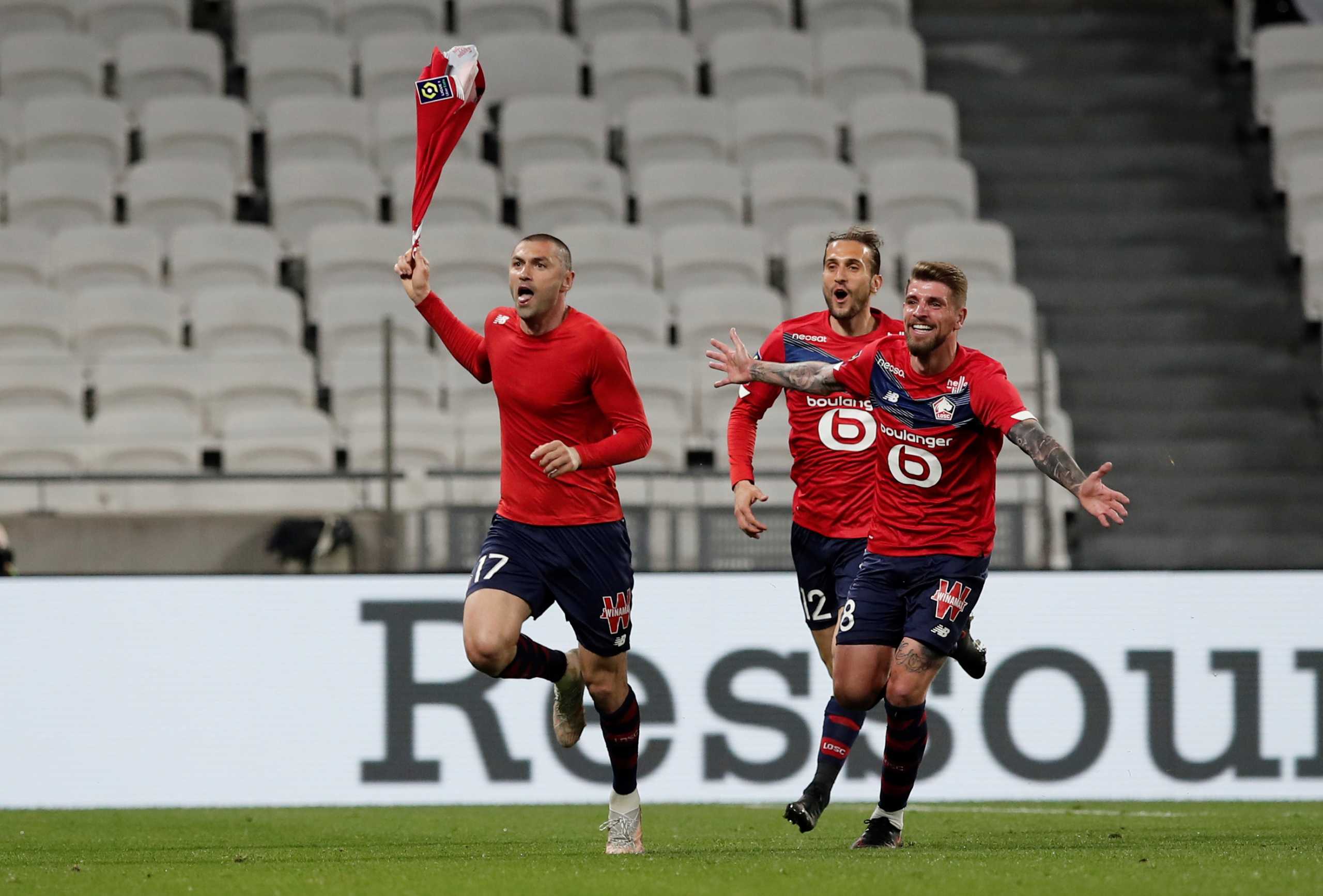 Soccer Football - Ligue 1 - Olympique Lyonnais v Lille - Groupama Stadium, Lyon, France - April 25, 2021 Lille's Burak Yilmaz celebrates scoring their third goal with teammates REUTERS
