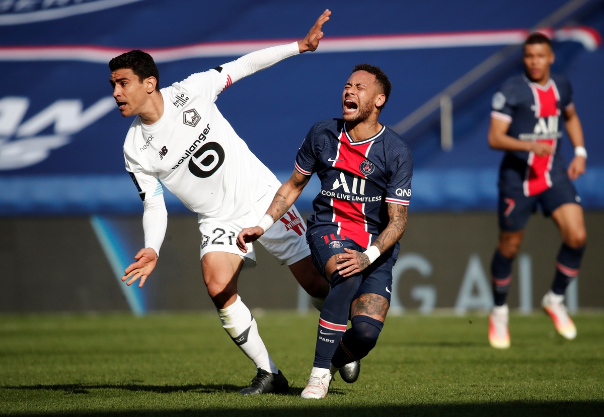 Soccer Football - Ligue 1 - Paris St Germain v Lille - Parc des Princes, Paris, France - April 3, 2021 Paris St Germain's Neymar in action with Lille's Benjamin Andre REUTERS