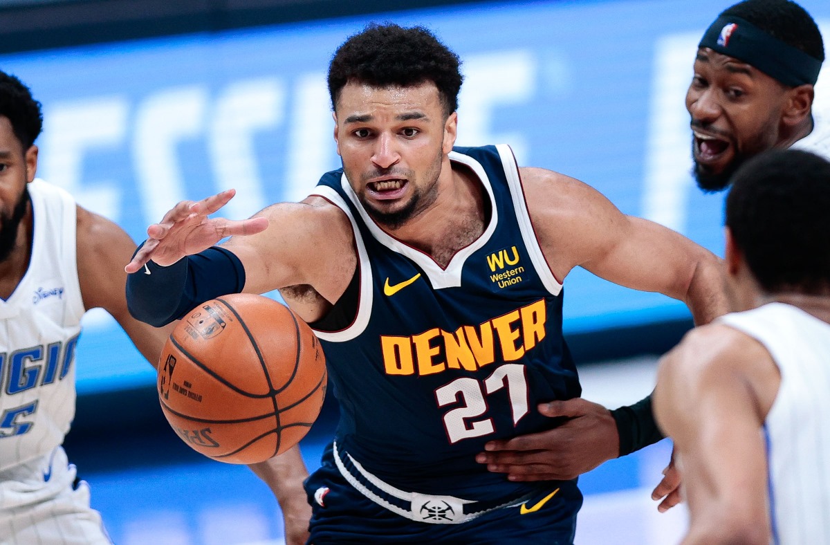 Apr 4, 2021; Denver, Colorado, USA; Denver Nuggets guard Jamal Murray (27) battles for the ball with Orlando Magic guard Chasson Randle (25) and guard Terrence Ross (31) and forward Chuma Okeke (3) in the third quarter at Ball Arena. Mandatory Credit: Isaiah J. Downing-USA TODAY Sports