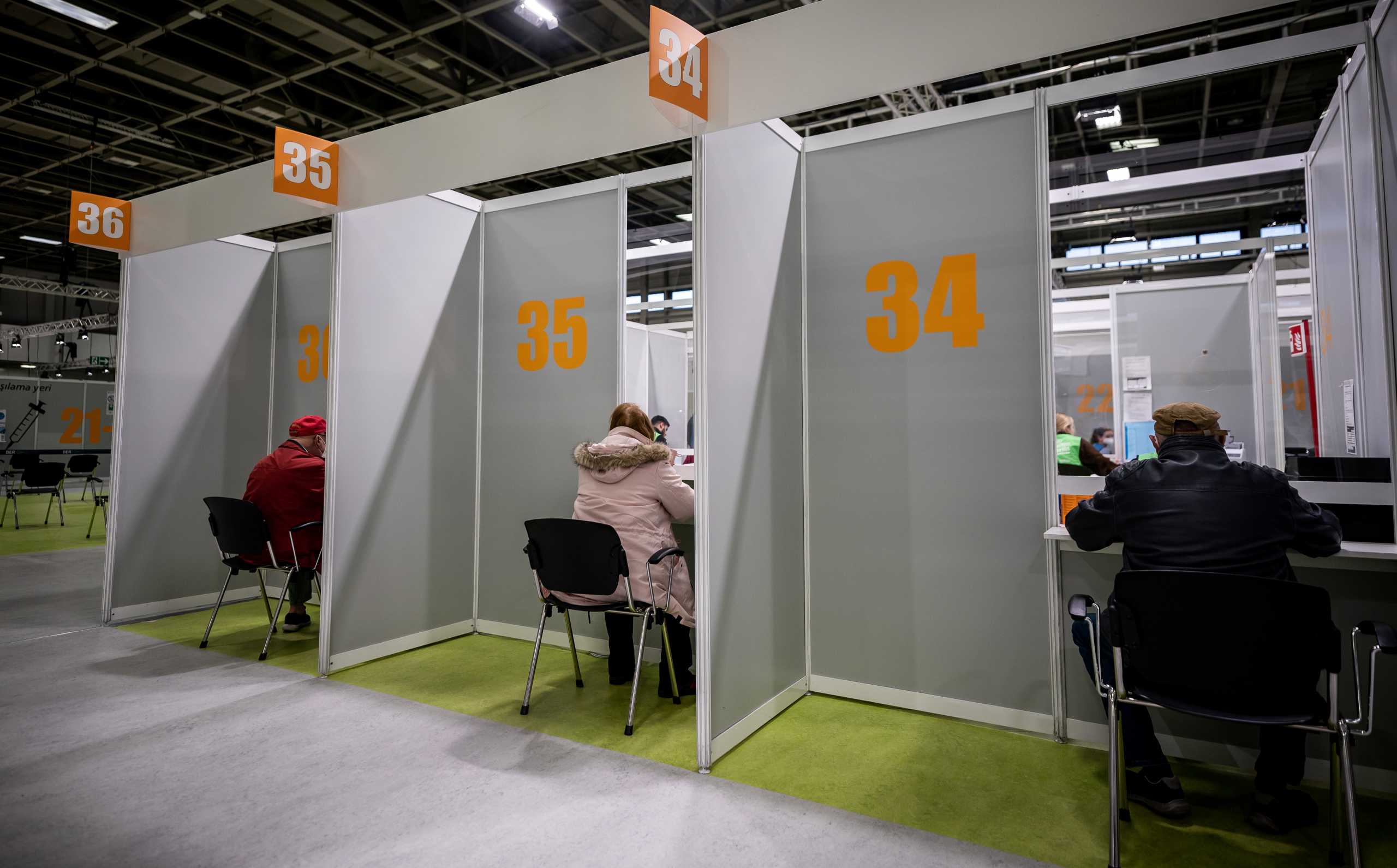 People register for the coronavirus disease (COVID-19) vaccination at the fairgrounds in Berlin, Germany, April 5, 2021.    Michael Kappeler