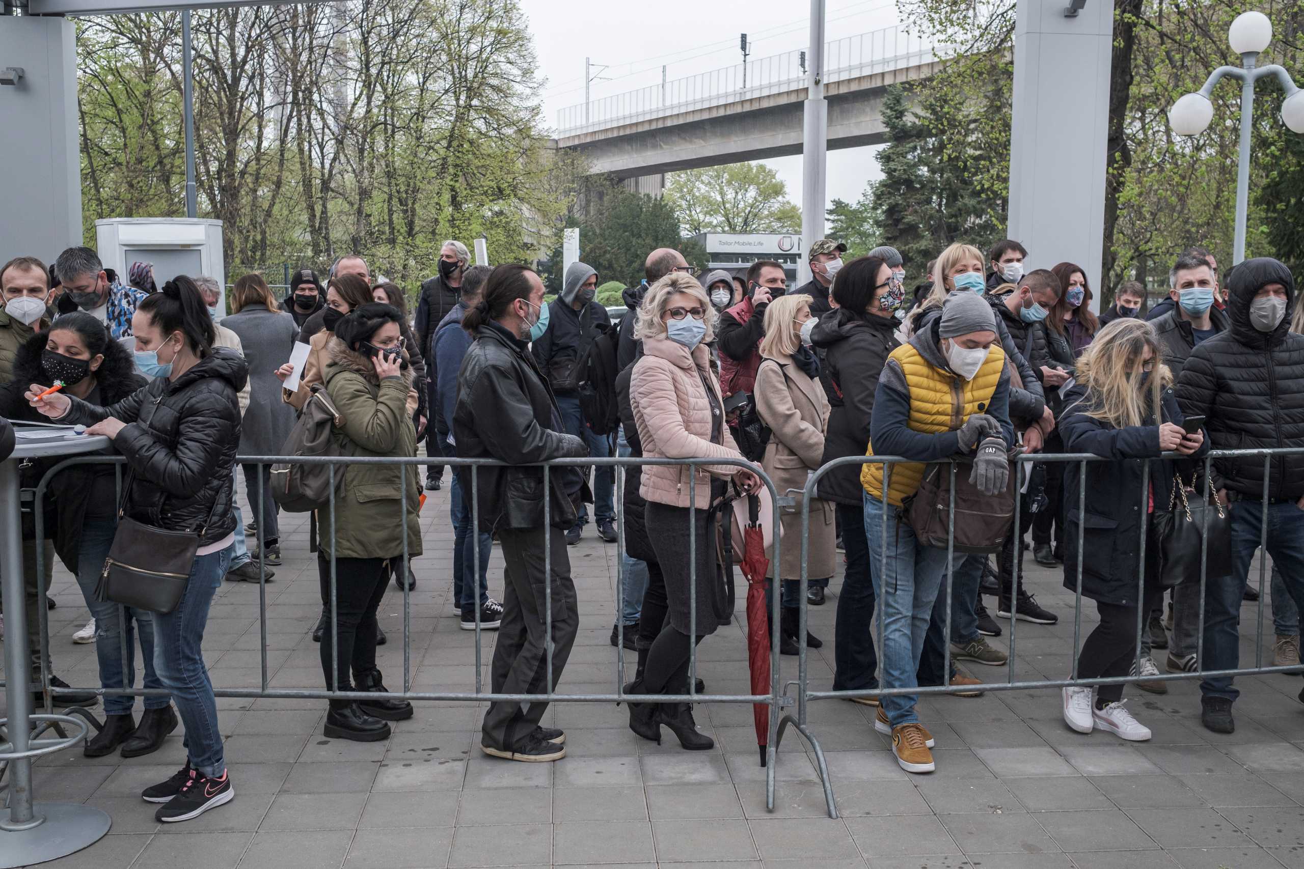 People wait in line to receive a second dose of the Pfizer-BioNTech vaccine against the coronavirus disease (COVID-19) at the hall three of the Belgrade Fair, in Belgrade, Serbia, April 13, 2021. REUTERS
