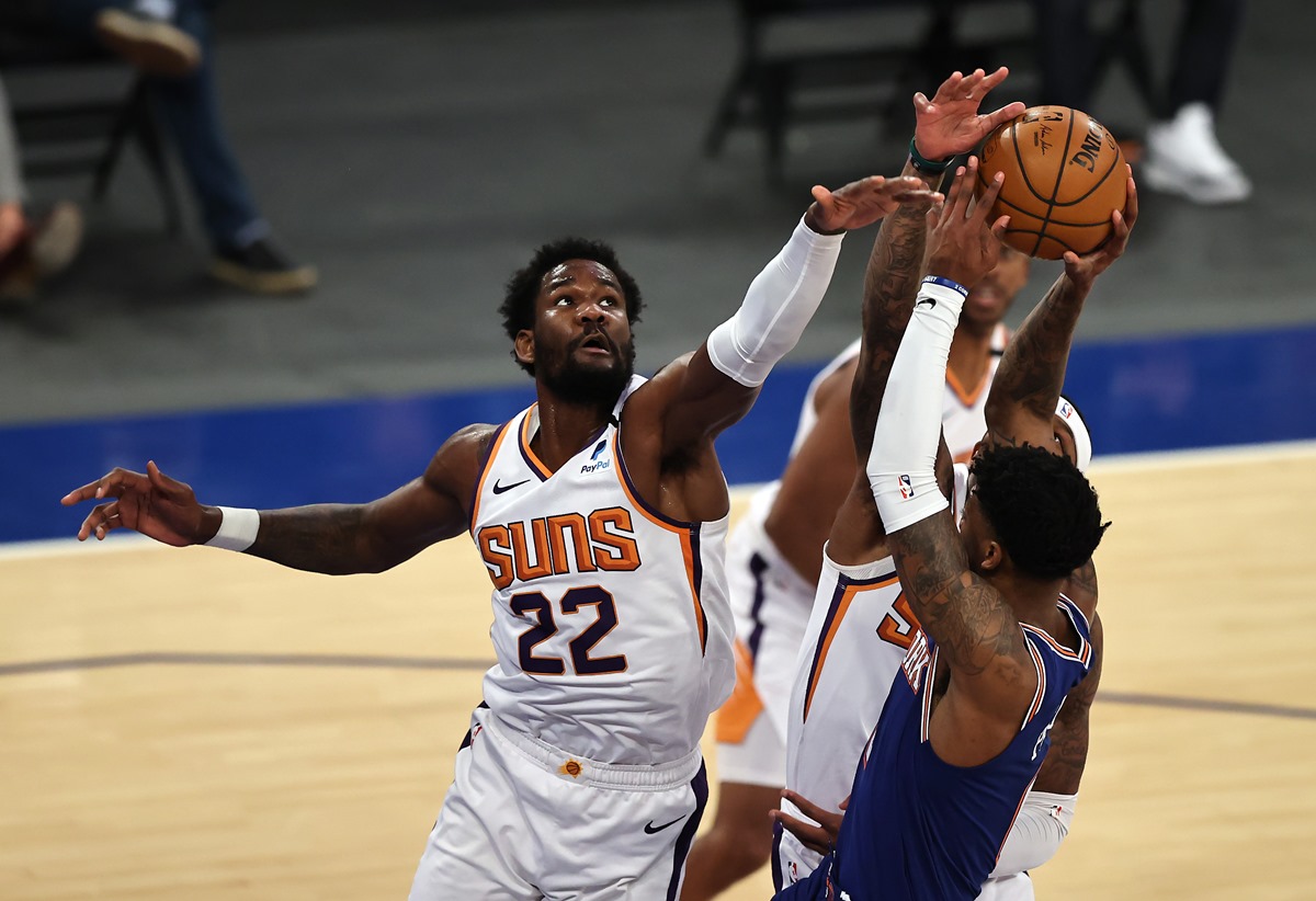 Apr 26, 2021; New York, New York, USA;  Elfrid Payton #6 of the New York Knicks heads for the net as Deandre Ayton #22 and Torrey Craig #12 of the Phoenix Suns defend in the first half at Madison Square Garden. Mandatory Credit:  Elsa