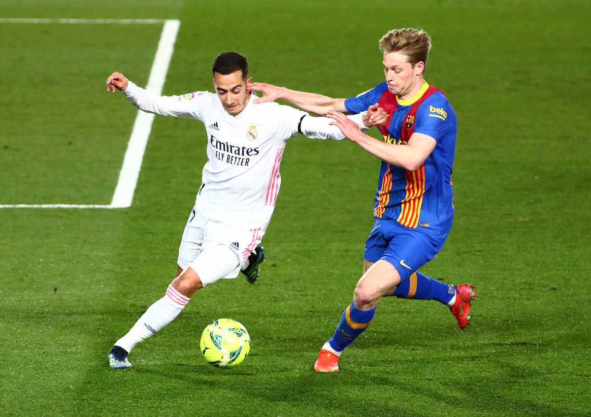 Soccer Football - La Liga Santander - Real Madrid v FC Barcelona - Estadio Alfredo Di Stefano, Madrid, Spain - April 10, 2021 Real Madrid's Lucas Vazquez in action with Barcelona's Frenkie de Jong REUTERS