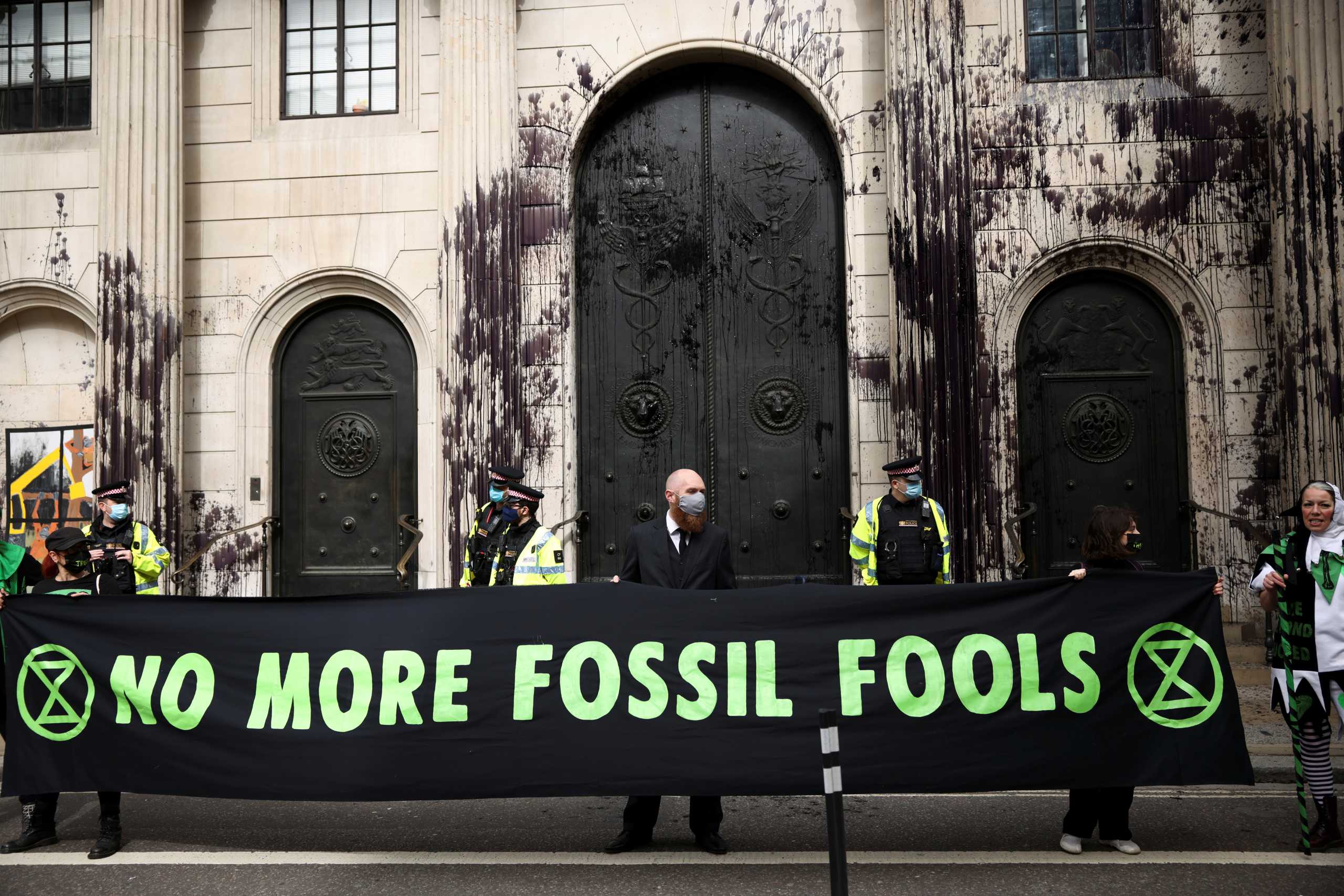 Activists from the Extinction Rebellion, a global environmental movement, protest outside the Bank of England, in London, Britain, April 1, 2021. REUTERS