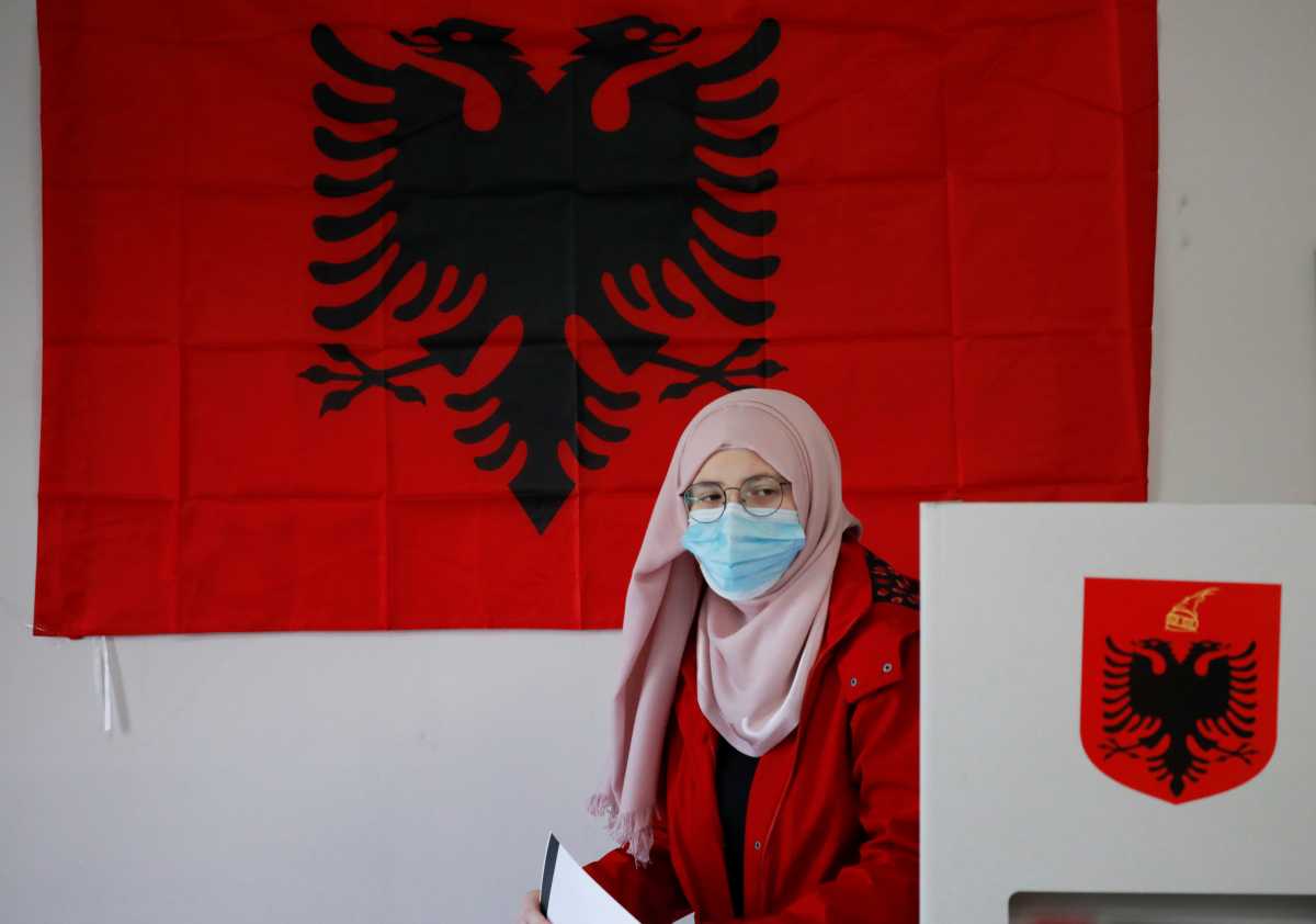 A woman attends voting during the parliamentary election, in Tirana, Albania April 25, 2021. REUTERS