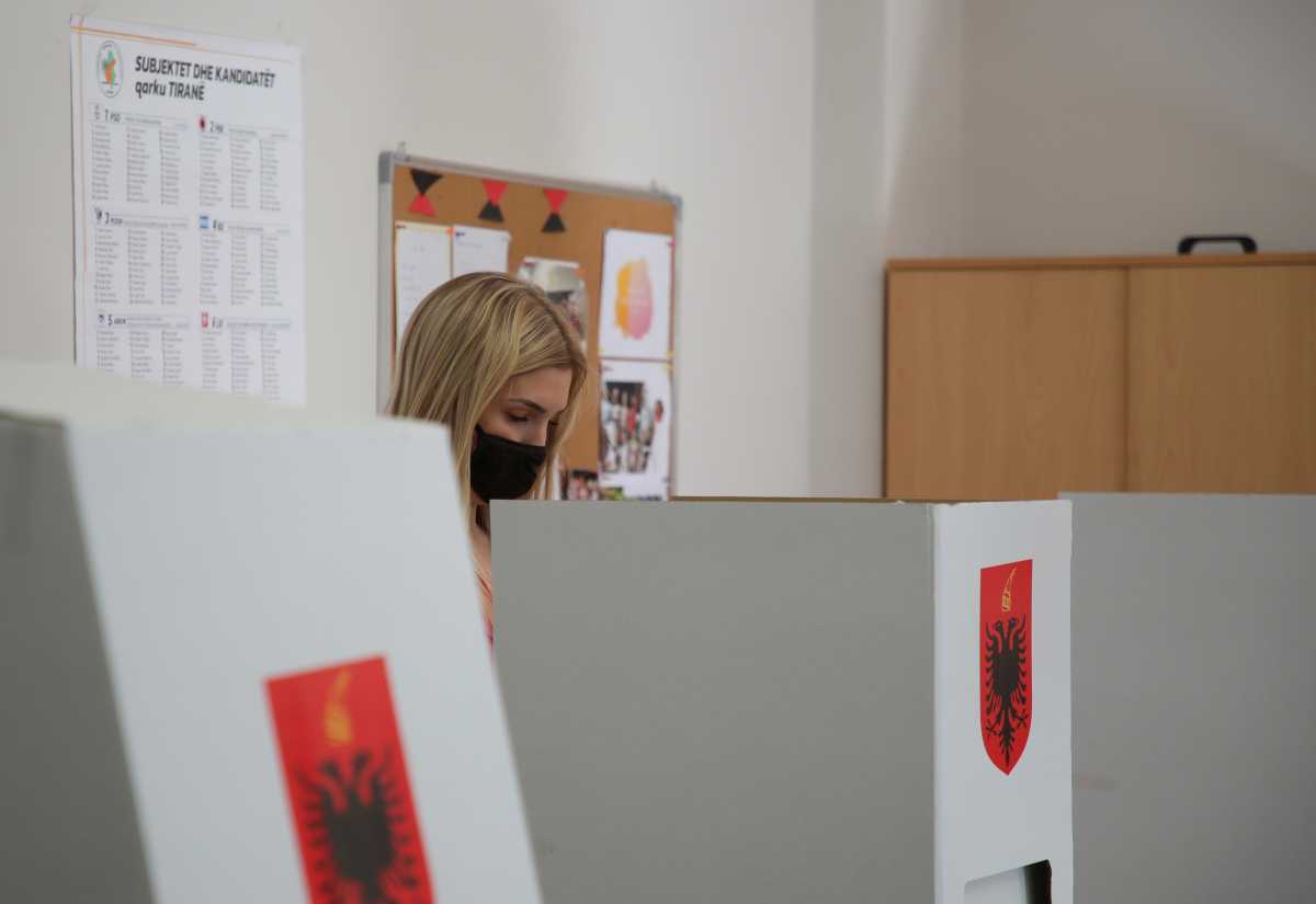 A woman attends voting during the parliamentary election, in Tirana, Albania April 25, 2021. REUTERS