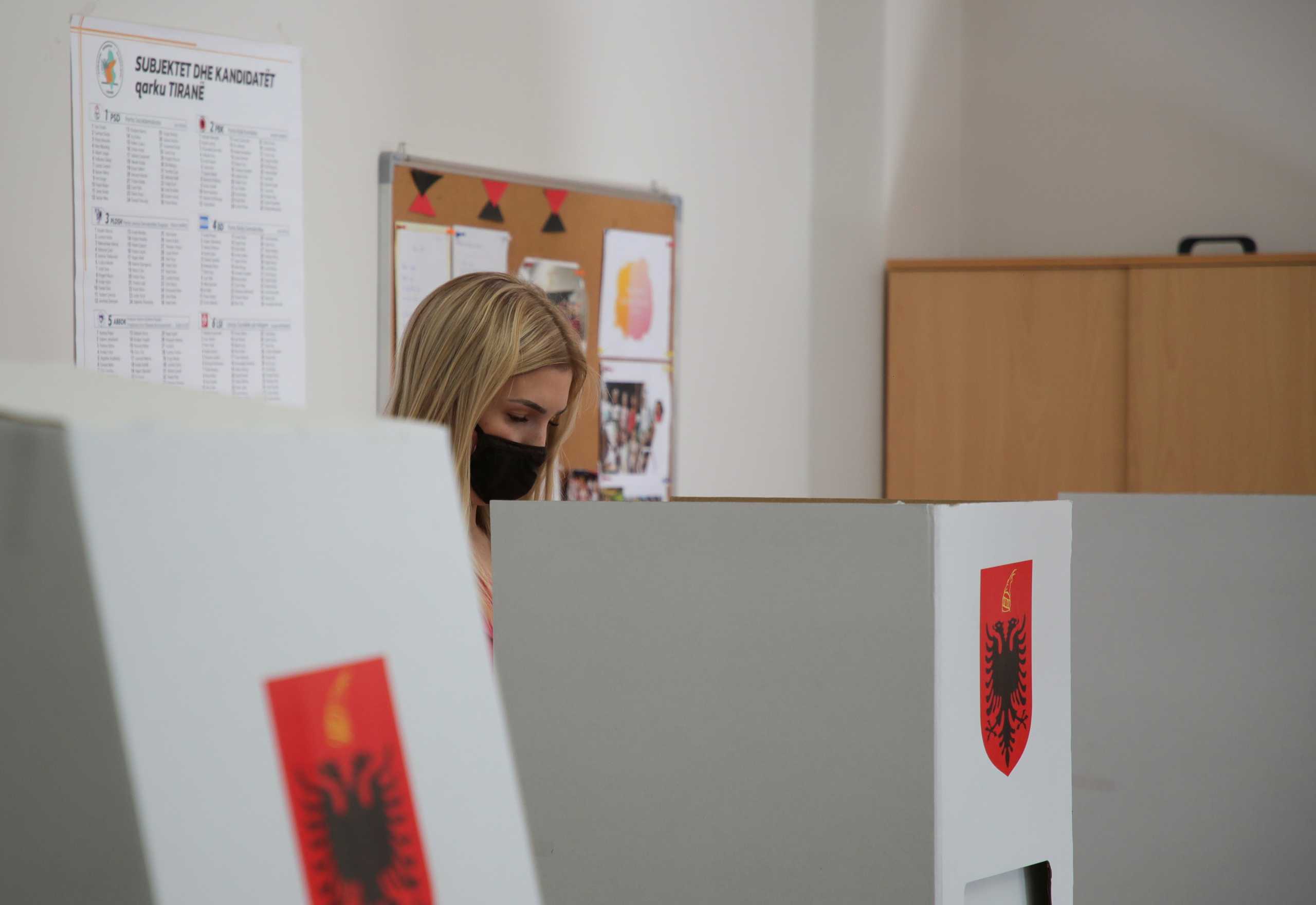 A woman attends voting during the parliamentary election, in Tirana, Albania April 25, 2021. REUTERS