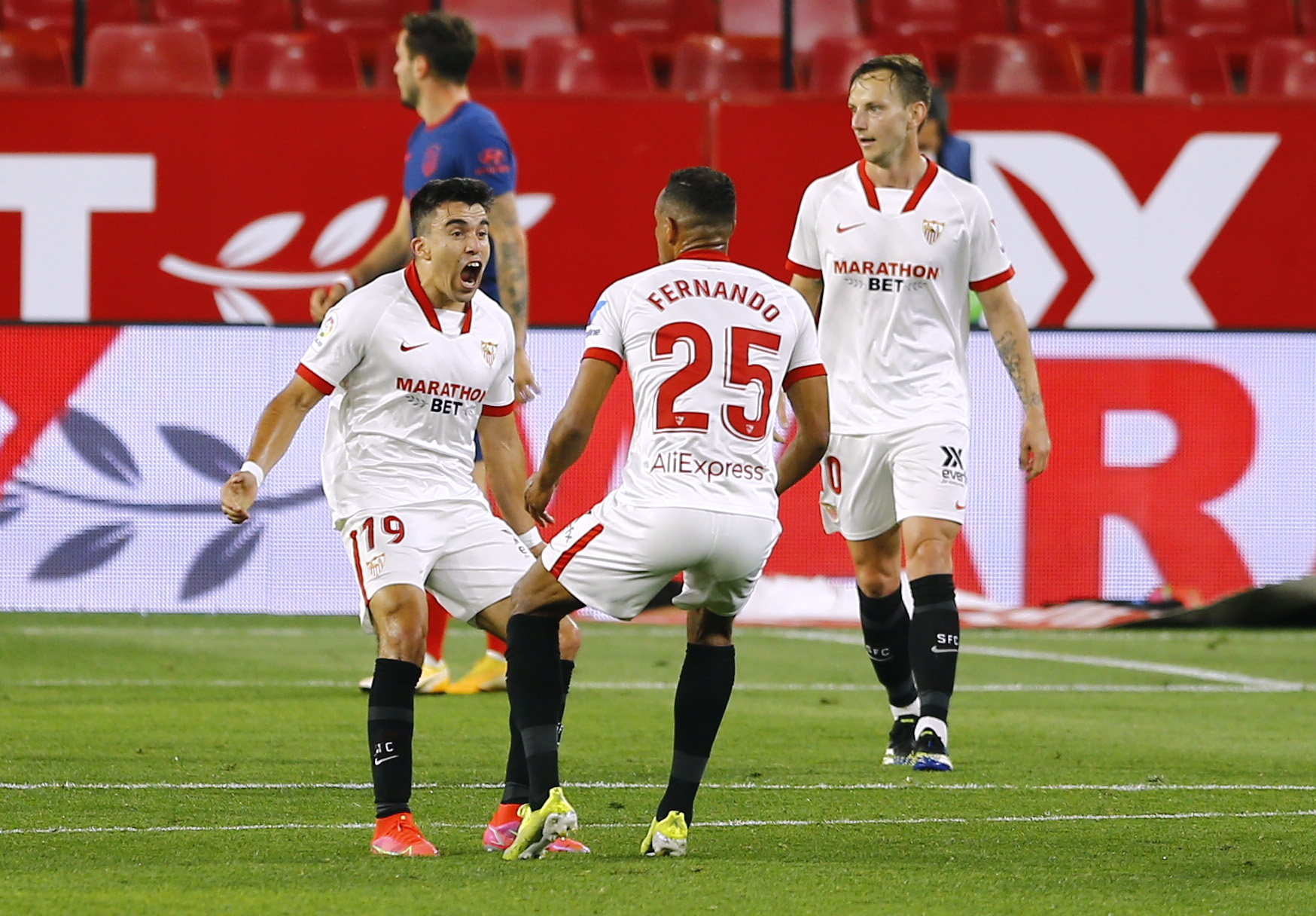 Soccer Football - La Liga Santander - Sevilla v Atletico Madrid - Ramon Sanchez Pizjuan, Seville, Spain - April 4, 2021 Sevilla's Marcos Acuna celebrates scoring their first goal with teammates REUTERS