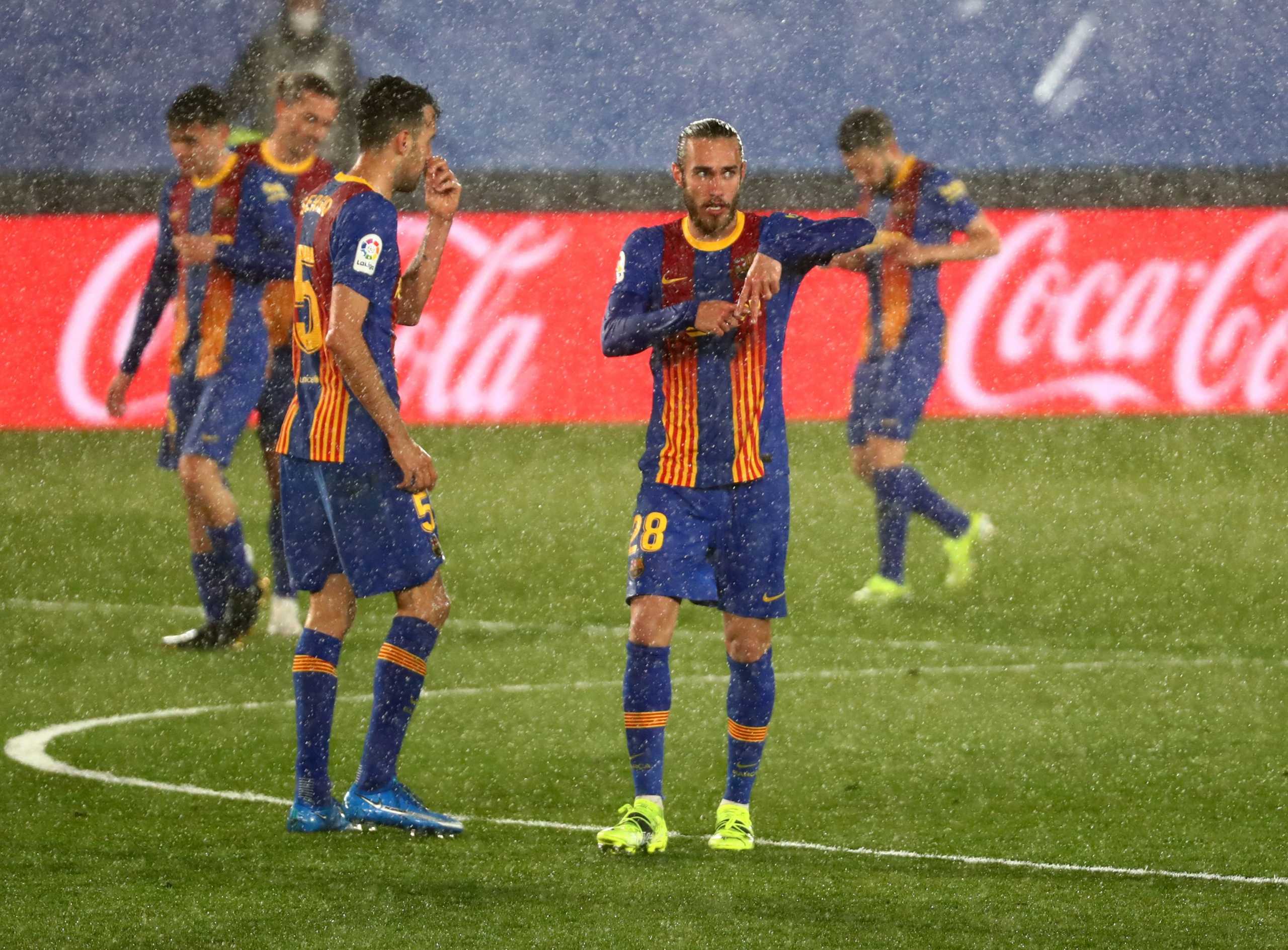 Soccer Football - La Liga Santander - Real Madrid v FC Barcelona - Estadio Alfredo Di Stefano, Madrid, Spain - April 10, 2021 Barcelona's Oscar Mingueza celebrates scoring their first goal with Sergio Busquets REUTERS
