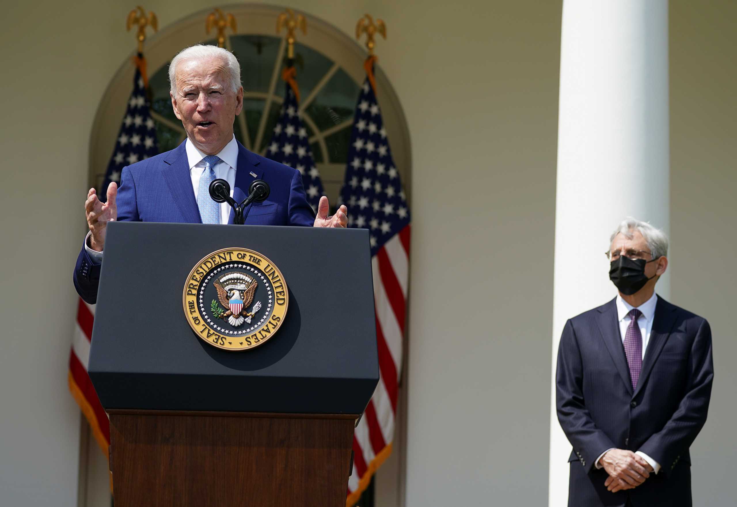 U.S. President Joe Biden is flanked by Attorney General Merrick Garland as he announces executive actions on gun violence prevention in the Rose Garden at the White House in Washington, U.S., April 8, 2021. REUTERS