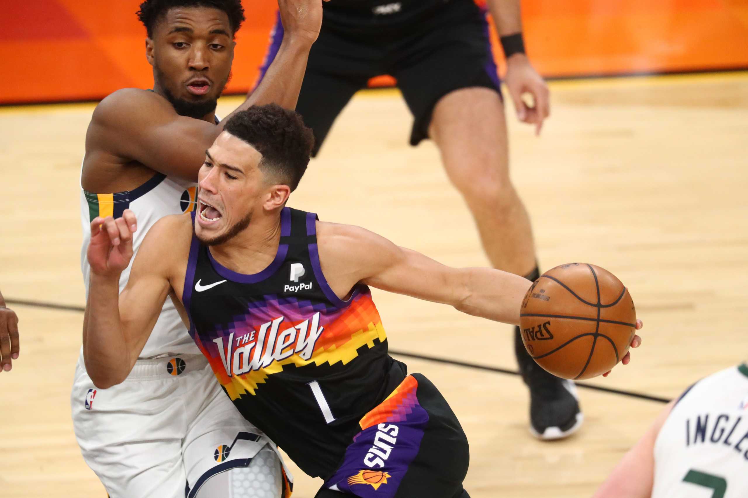 Apr 7, 2021; Phoenix, Arizona, USA; Phoenix Suns guard Devin Booker (1) reacts as he drives to the basket against Utah Jazz guard Donovan Mitchell during the first half at Phoenix Suns Arena. Mandatory Credit: Mark J. Rebilas-USA TODAY Sports