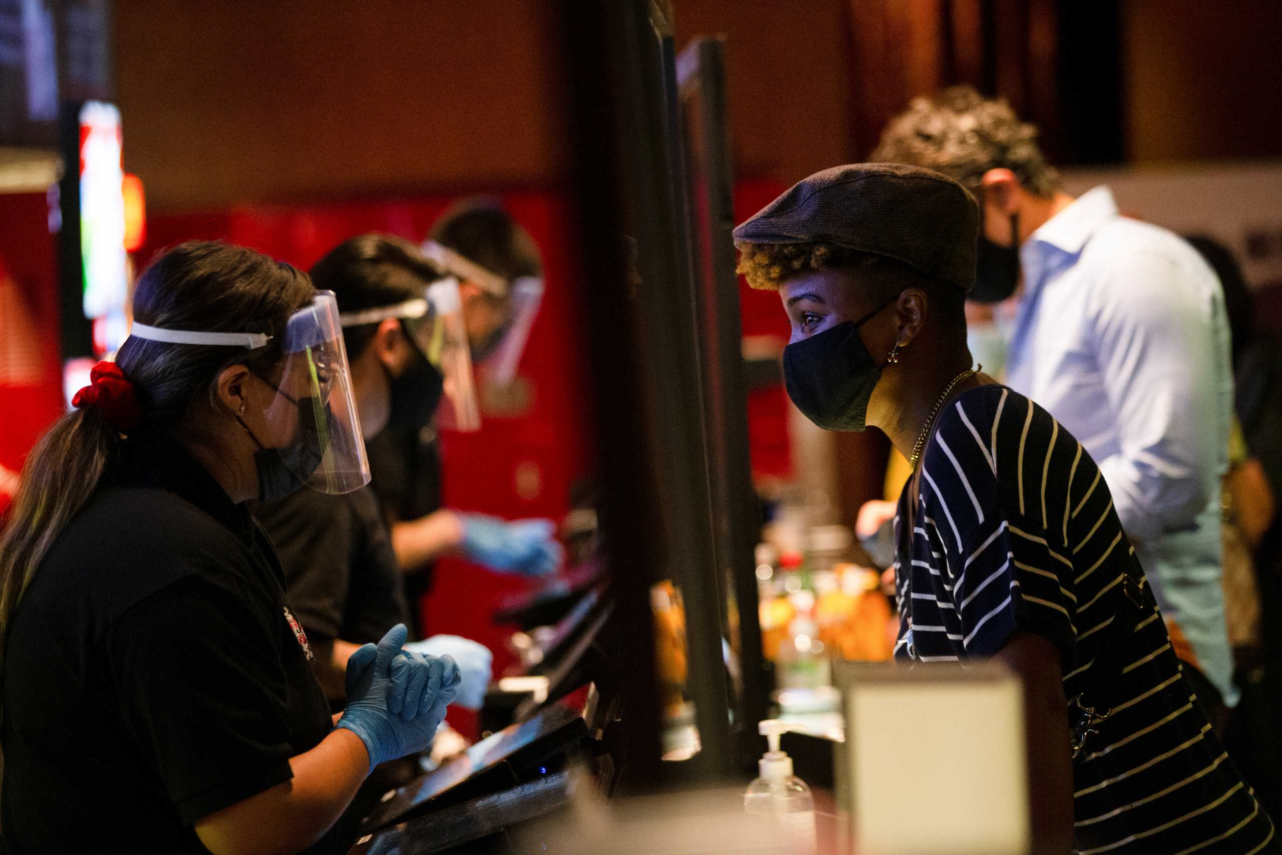A moviegoer shops at concessions before the movie "Godzilla vs. Kong" on the reopening day of the TCL Chinese theatre during the outbreak of the coronavirus disease (COVID-19), in Los Angeles, California, U.S., March 31, 2021.  REUTERS