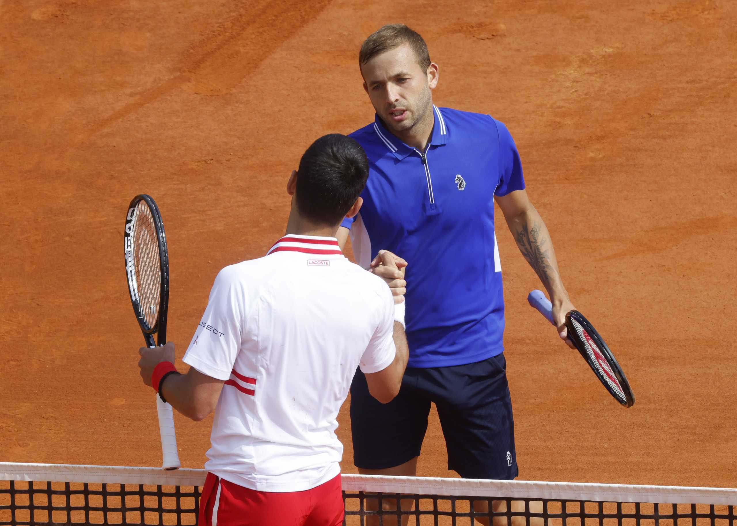 Tennis - ATP Masters 1000 - Monte Carlo Masters - Monte-Carlo Country Club, Roquebrune-Cap-Martin, France - April 15, 2021 Britain's Dan Evans and Serbia's Novak Djokovic shake hands after their third round match REUTERS