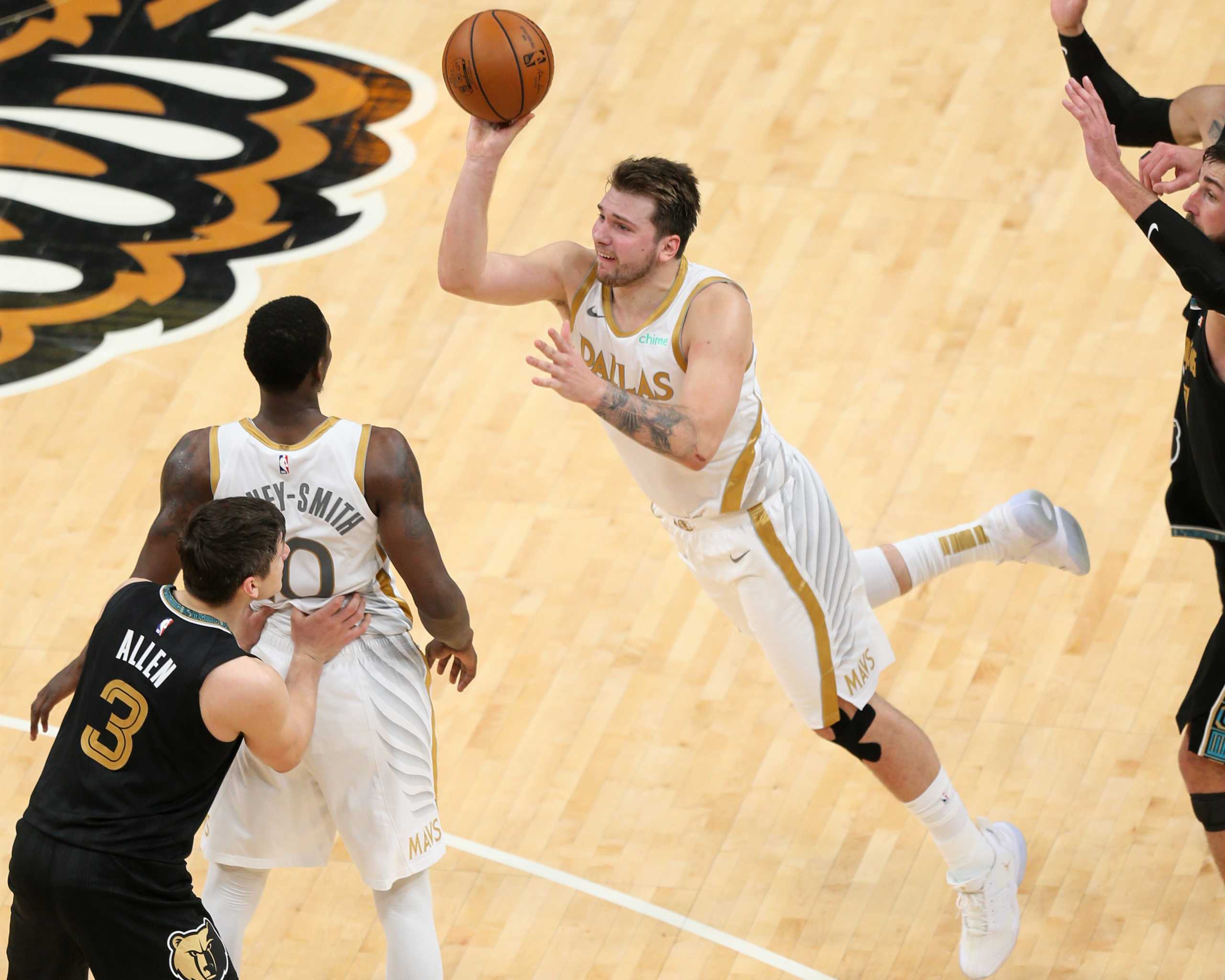 Apr 14, 2021; Memphis, Tennessee, USA; Dallas Mavericks  guard Luka Doncic (77) shoots a three-point basket against the Memphis Grizzlies as time expired in the fourth quarter at FedExForum. Mandatory Credit: Nelson Chenault-USA TODAY Sports