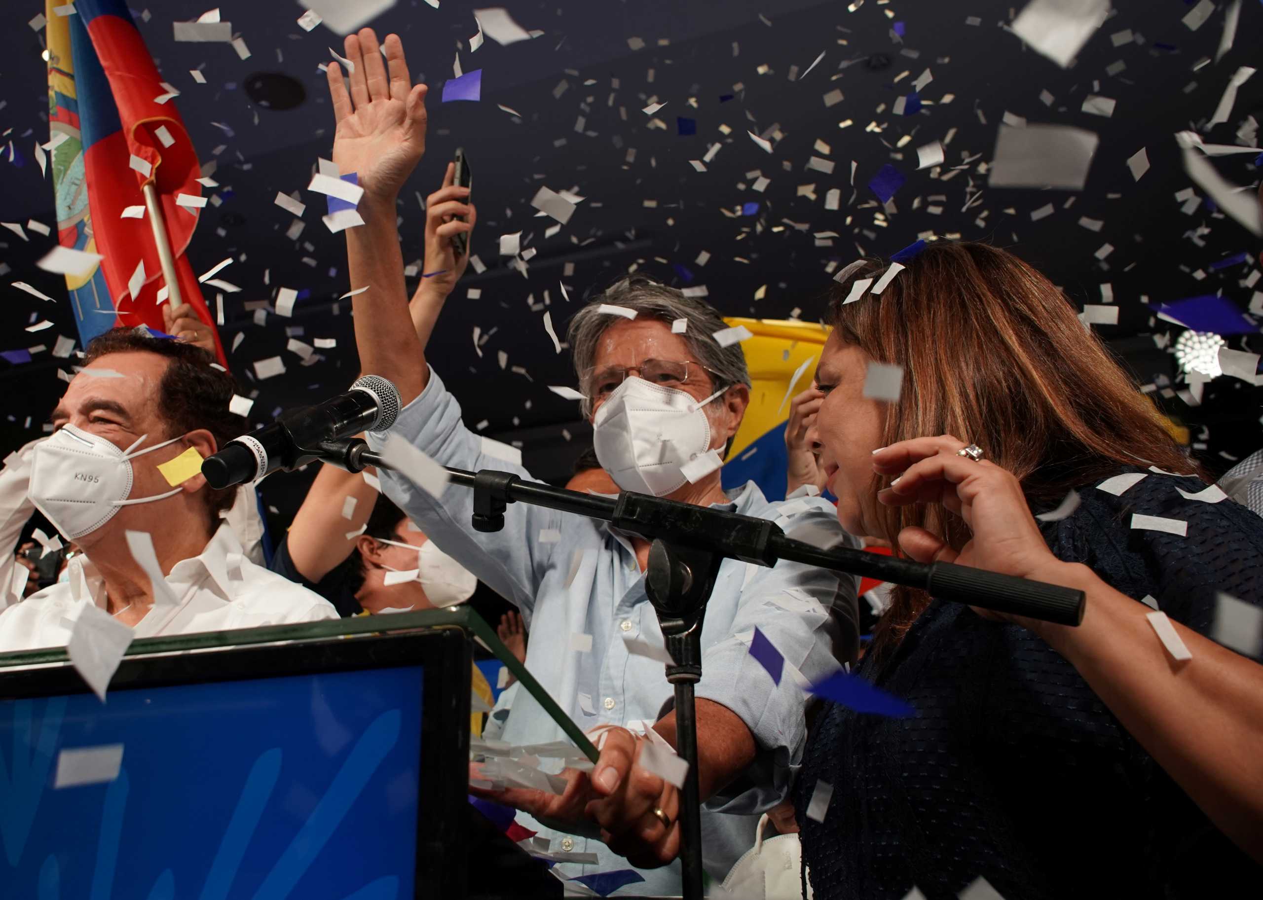 Ecuadorean banker Guillermo Lasso (C) waves to supporters after winning the presidential runoff vote, in Guayaquil, Ecuador April 11, 2021. REUTERS