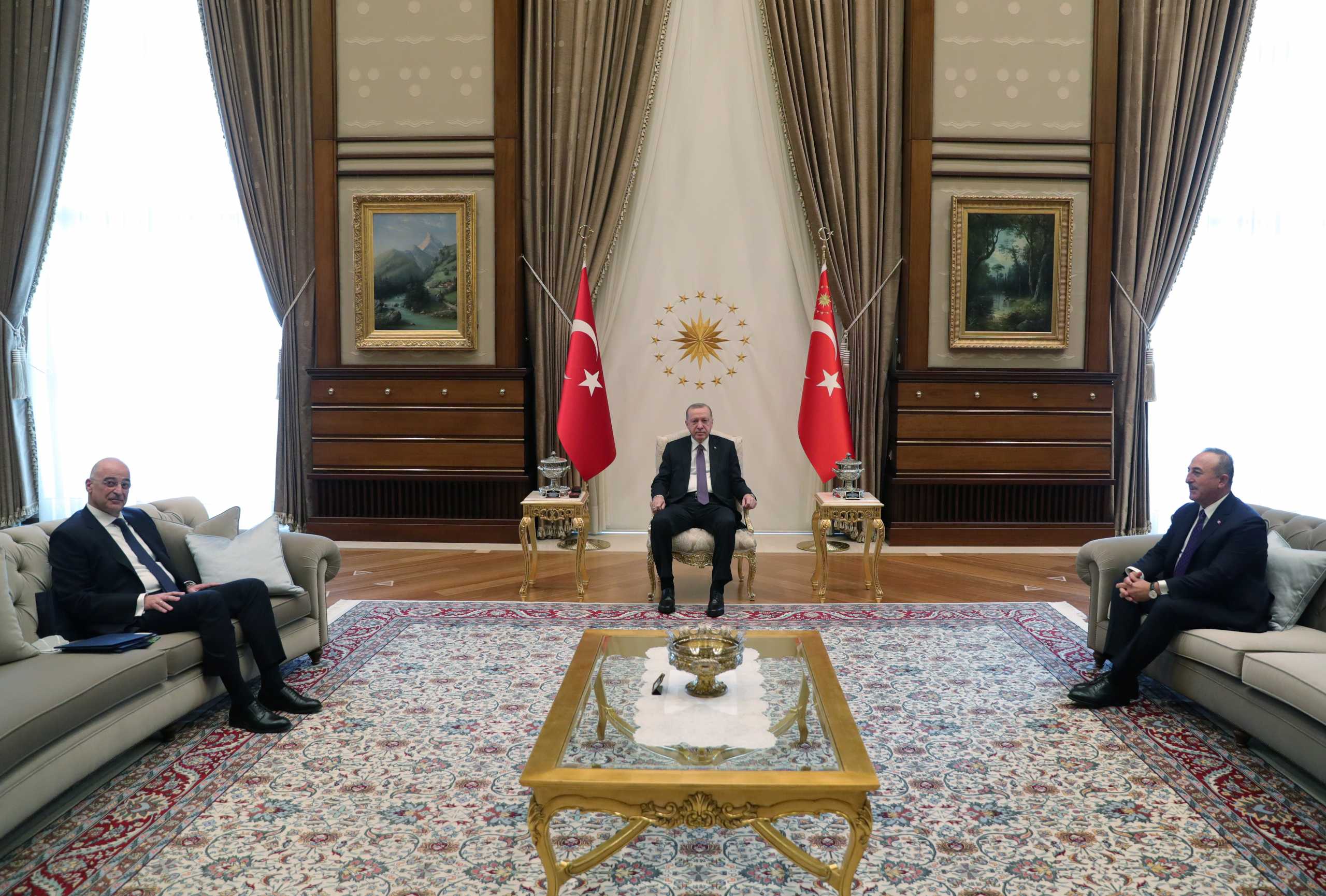 Turkish President Tayyip Erdogan, accompanied by his Foreign Minister Mevlut Cavusoglu, meets with Greek Foreign Minister Nikos Dendias in Ankara, Turkey April 15, 2021. Presidential Press Office