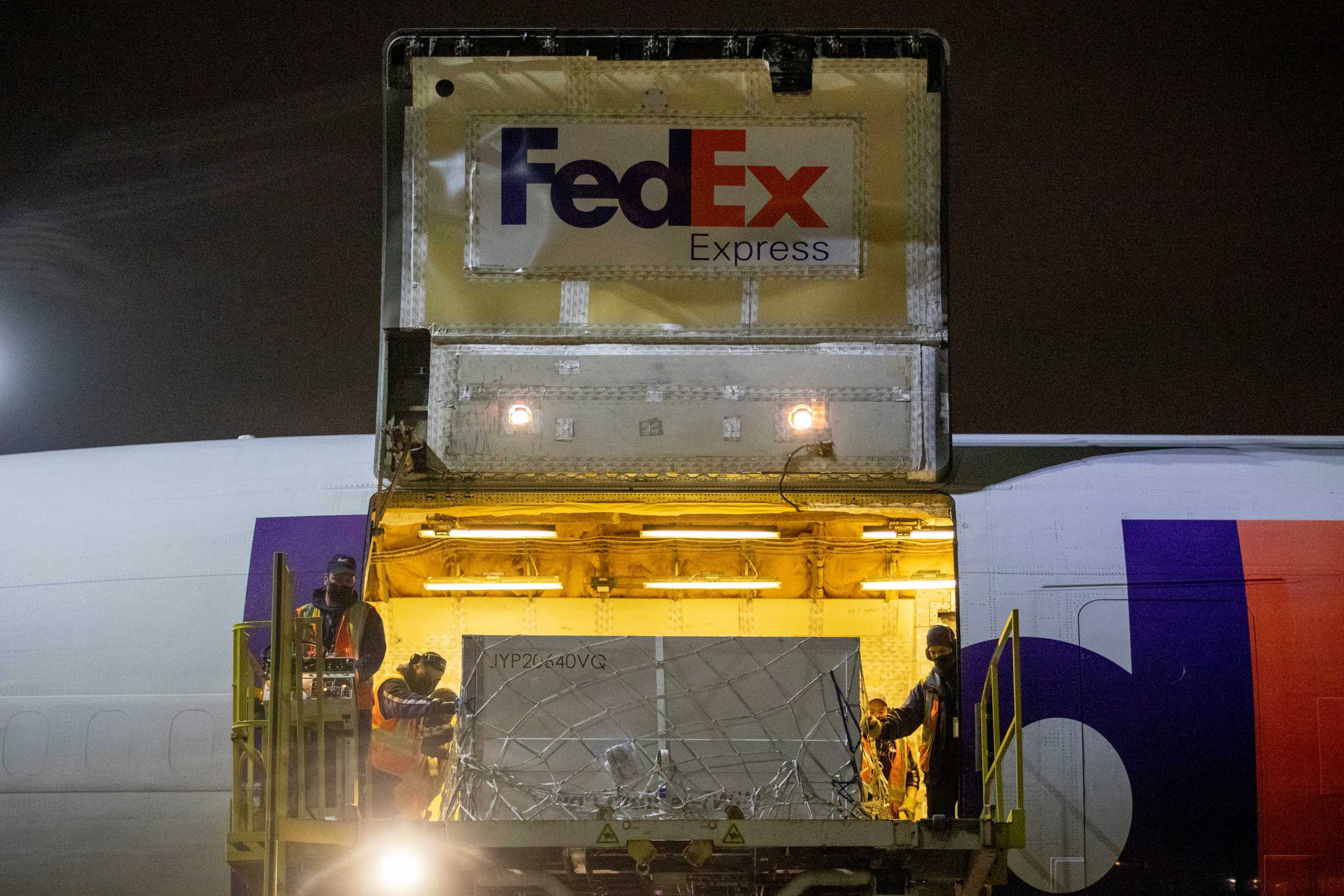 FedEx employees unload a shipment from Europe containing doses of the Moderna vaccine against the coronavirus disease (COVID-19) at Toronto Pearson Airport in Mississauga, Ontario, Canada March 24, 2021. REUTERS