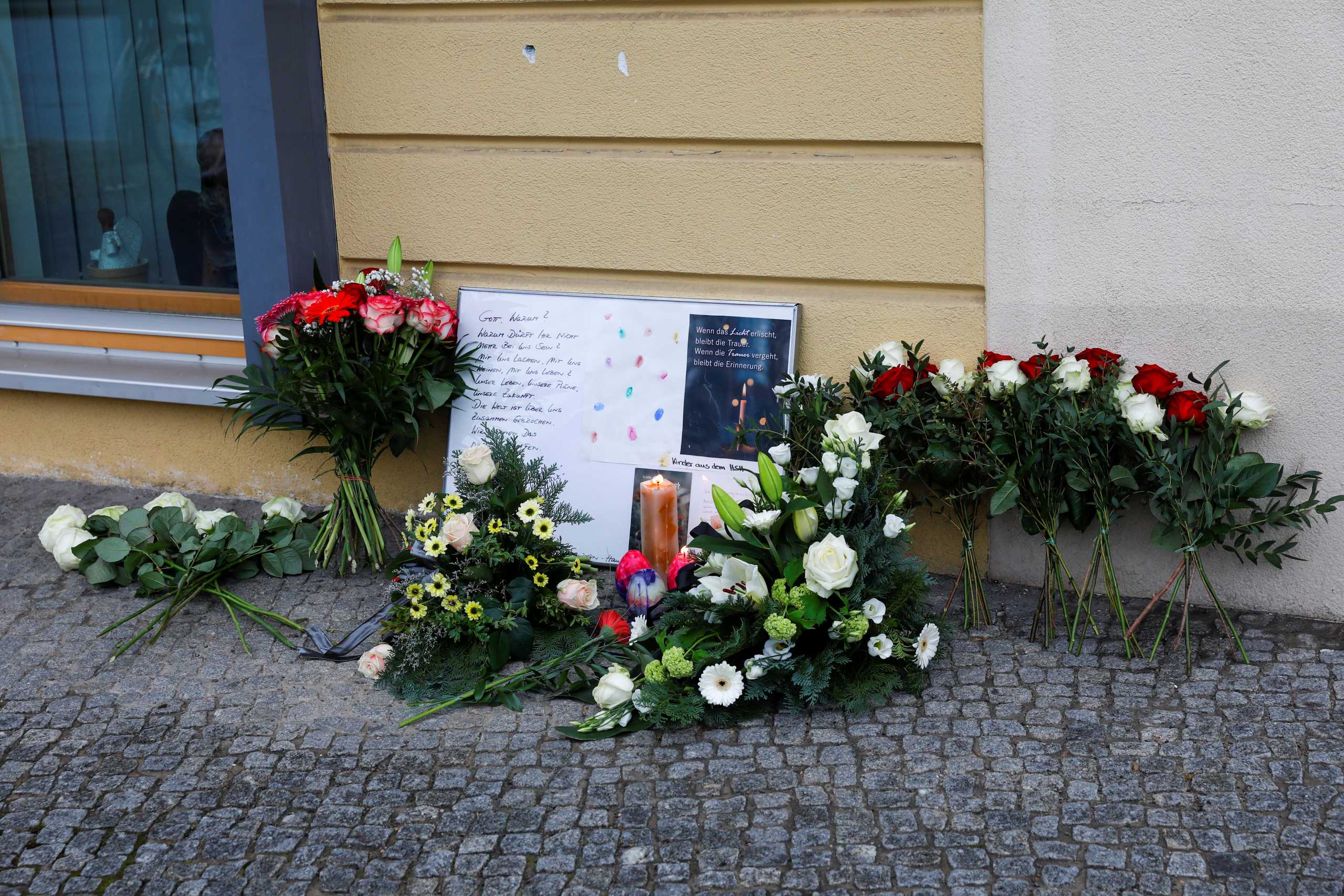 Messages and flowers are seen outside the Oberlin Clinic, following the arrest of a 51-year-old woman, after four people were found dead and another seriously injured at a hospital, in Potsdam, Germany, April 29, 2021. REUTERS
