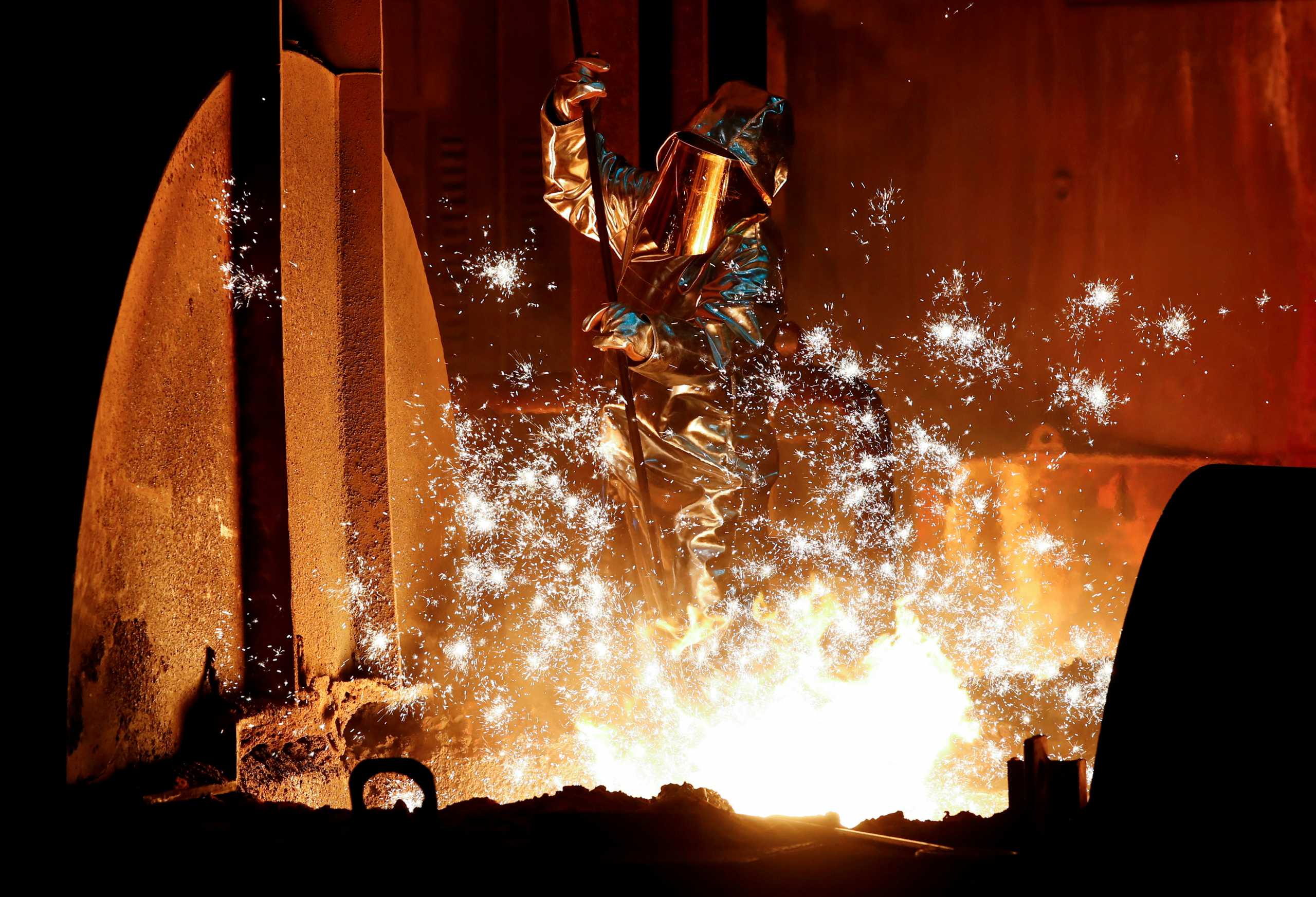 FILE PHOTO: A steel worker of Germany's industrial conglomerate ThyssenKrupp AG takes a sample of raw iron from a blast furnace at Germany's largest steel factory in Duisburg, Germany, January 28, 2019. REUTERS