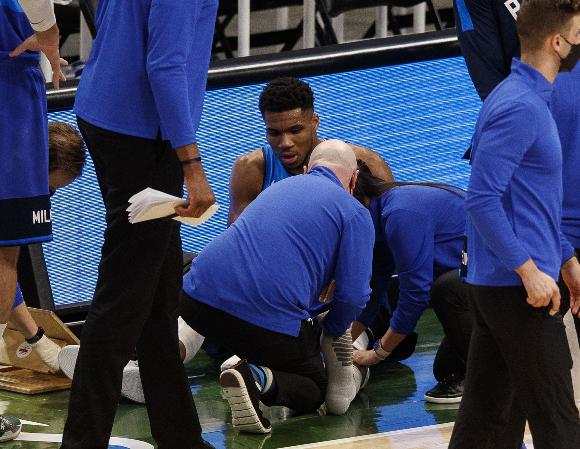 Apr 19, 2021; Milwaukee, Wisconsin, USA;  Milwaukee Bucks forward Giannis Antetokounmpo (34) is attended to after being injured during overtime against the Phoenix Suns at Fiserv Forum. Mandatory Credit: Jeff Hanisch-USA TODAY Sports