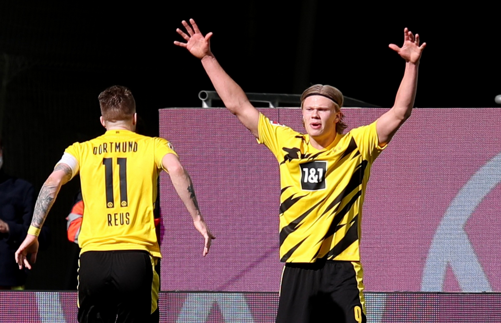 Soccer Football - Bundesliga - VfL Wolfsburg v Borussia Dortmund - Volkswagen Arena, Wolfsburg, Germany - April 24, 2021 Borussia Dortmund's Erling Braut Haaland celebrates scoring their second goal with Marco Reus Pool via REUTERS